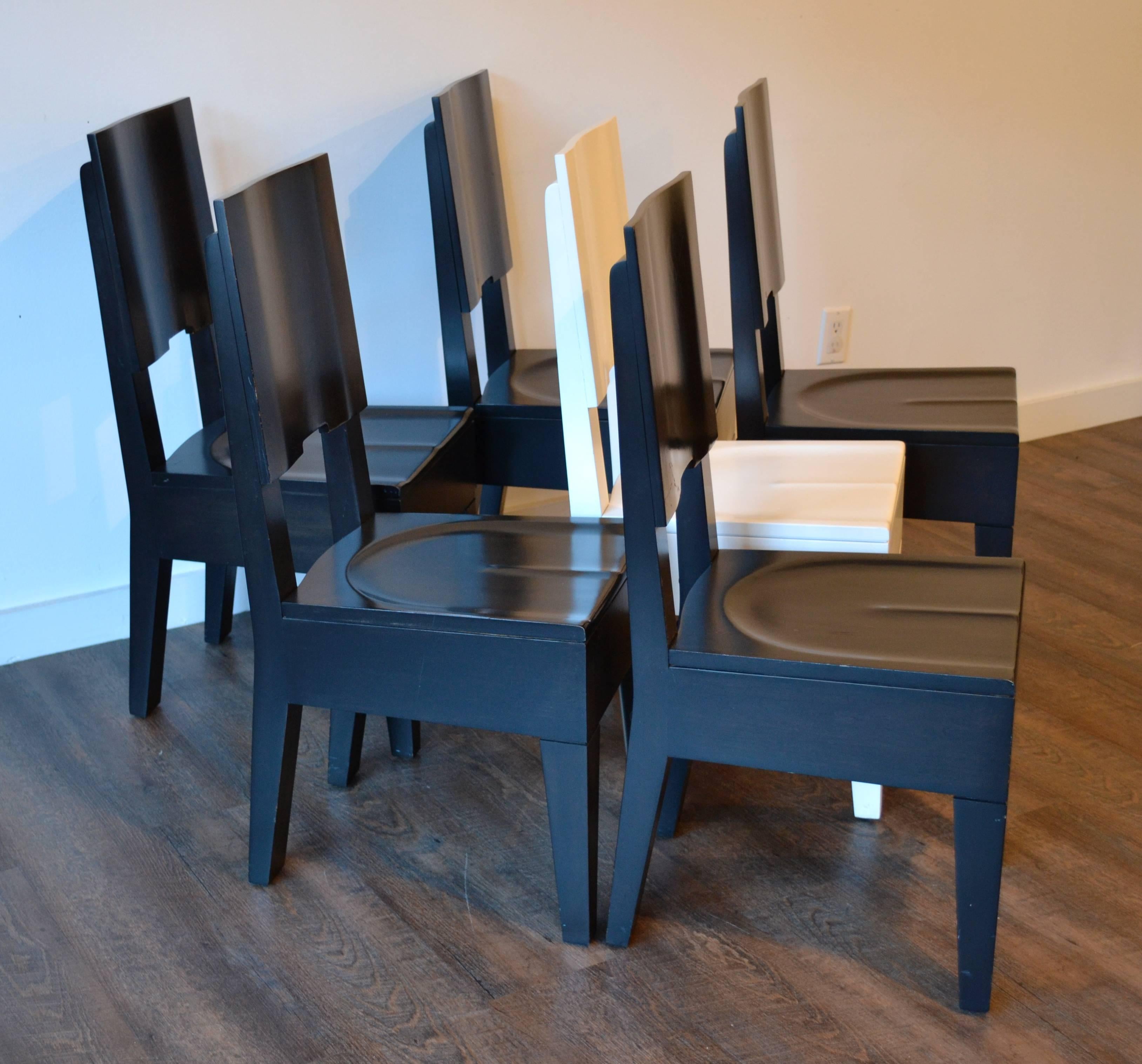 set of six very rare dining chairs by american artist roy mcmakin.  wood construction, five black lacquer and one white.