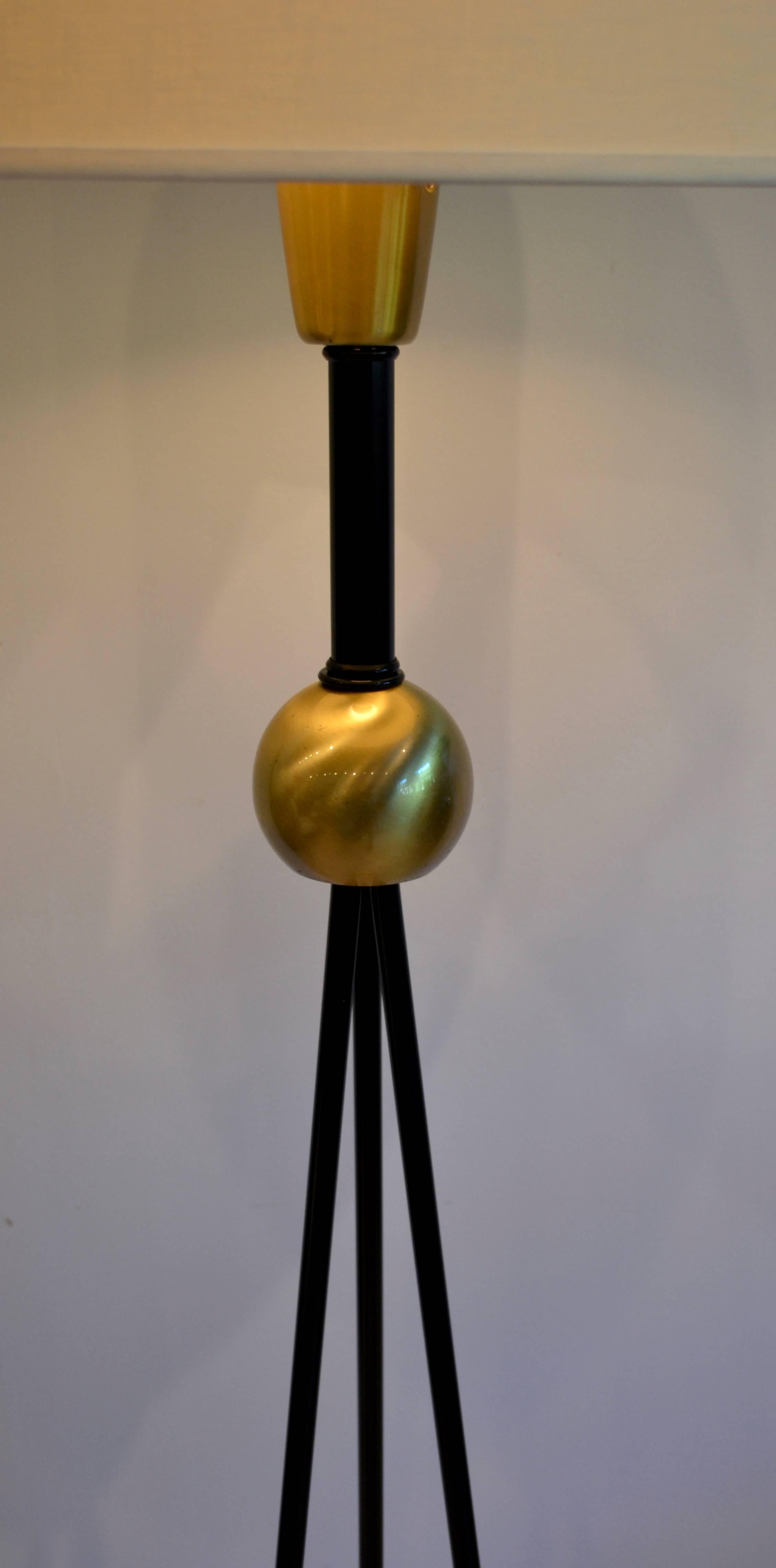 Classic Mid-Century Modern brass and iron floor lamp by Gerald Thurston for Lightolier. Circular base and sphere joinery detailing with black metal tripod base. Rewired and ready to go!