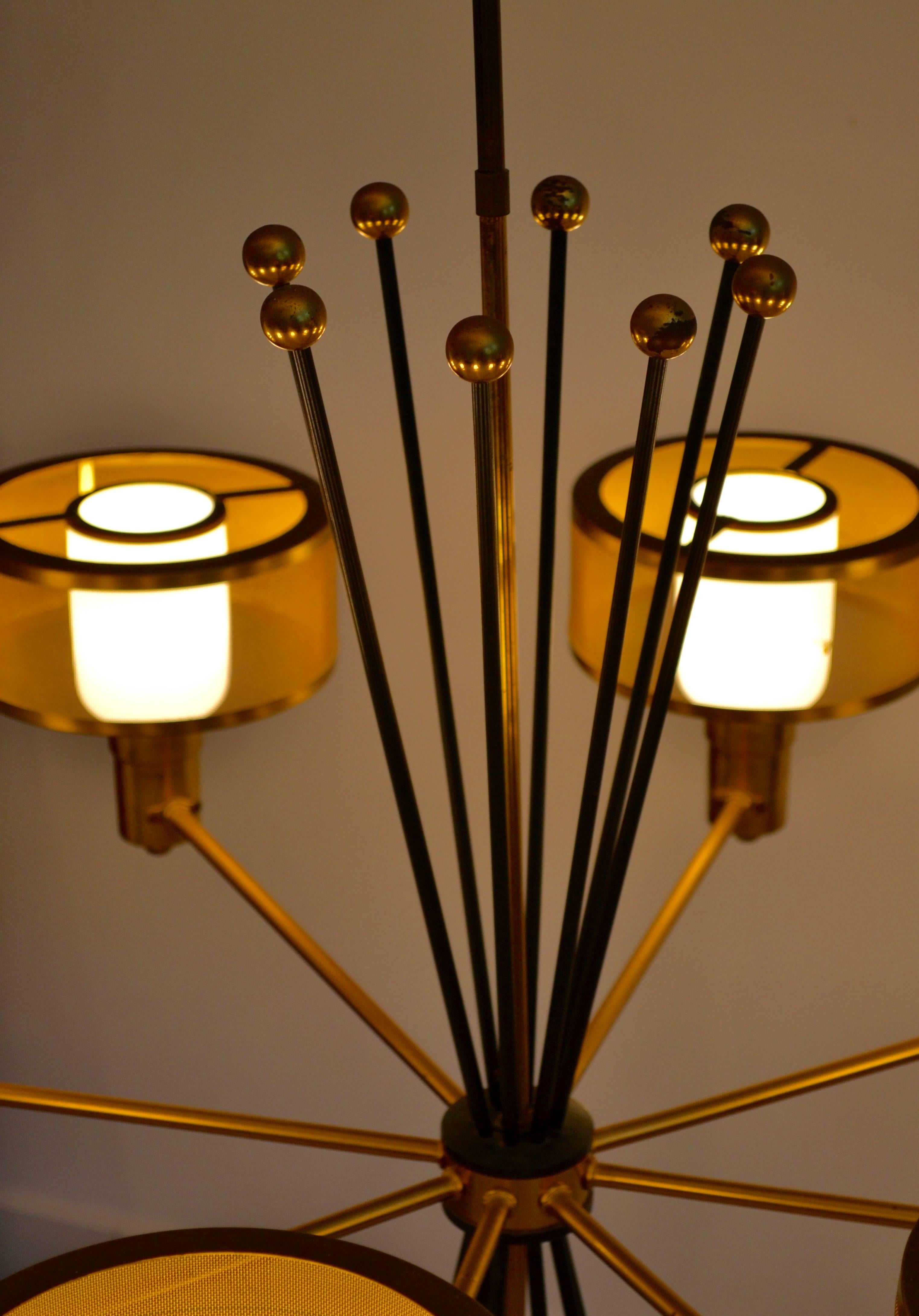 Incredibly cool Mid-Century Modern eight-light brass chandelier designed by Gerald Thurston for Lightolier. The chandelier has eight-light diffusers with brass mesh shades and eight black metal rods topped with brass spheres. All original. Simply