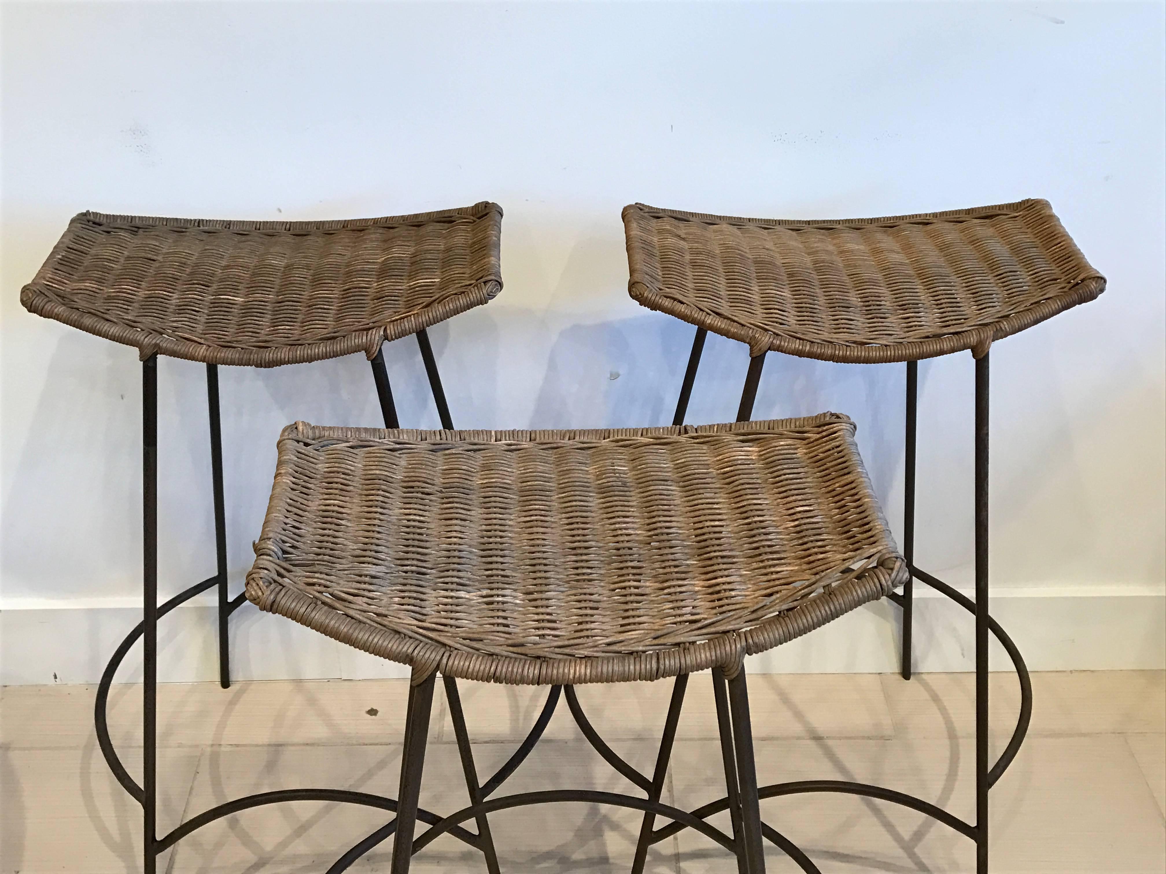 Three Arthur Umanoff iron and rattan bar stools. Mid-Century Modern.