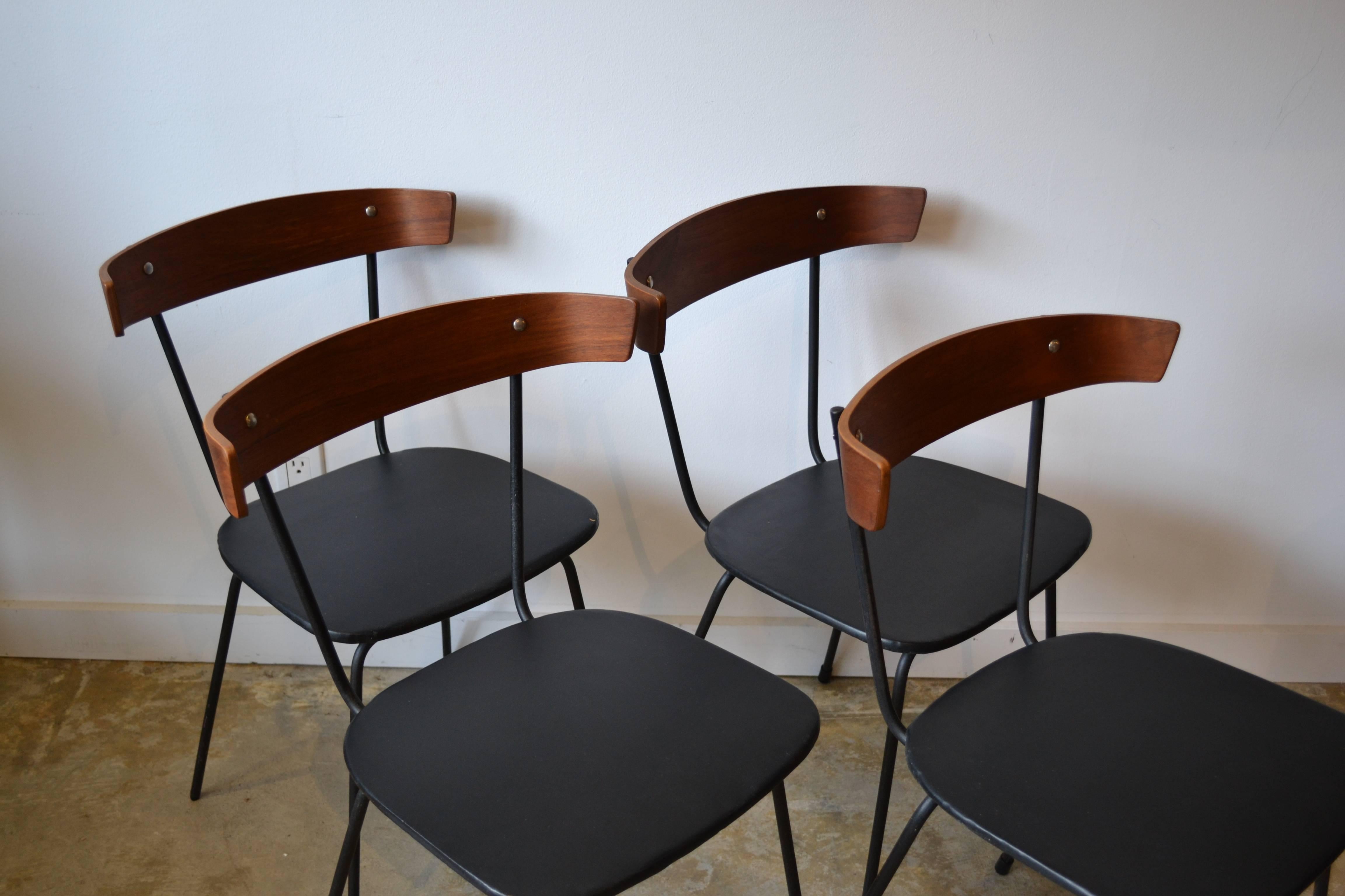 Four Mid-Century Modern iron and bentwood dining chairs in the style of Paul McCobb.