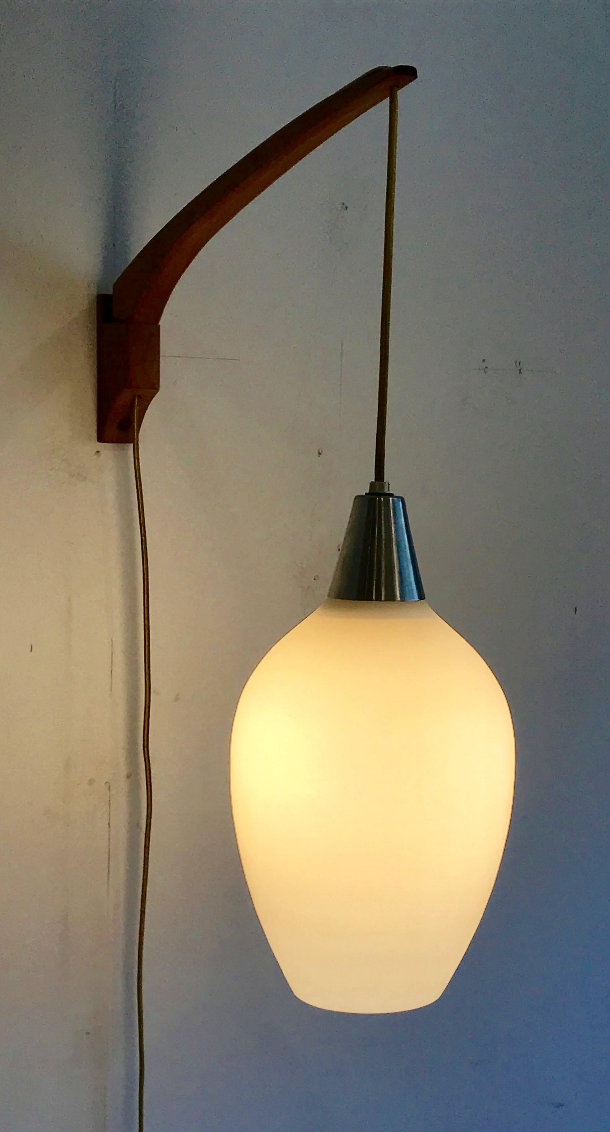 Gorgeous minimal pair of satin glass and teak wall mount pendant lights or sconces for Stilnovo, Italy, 1950s.