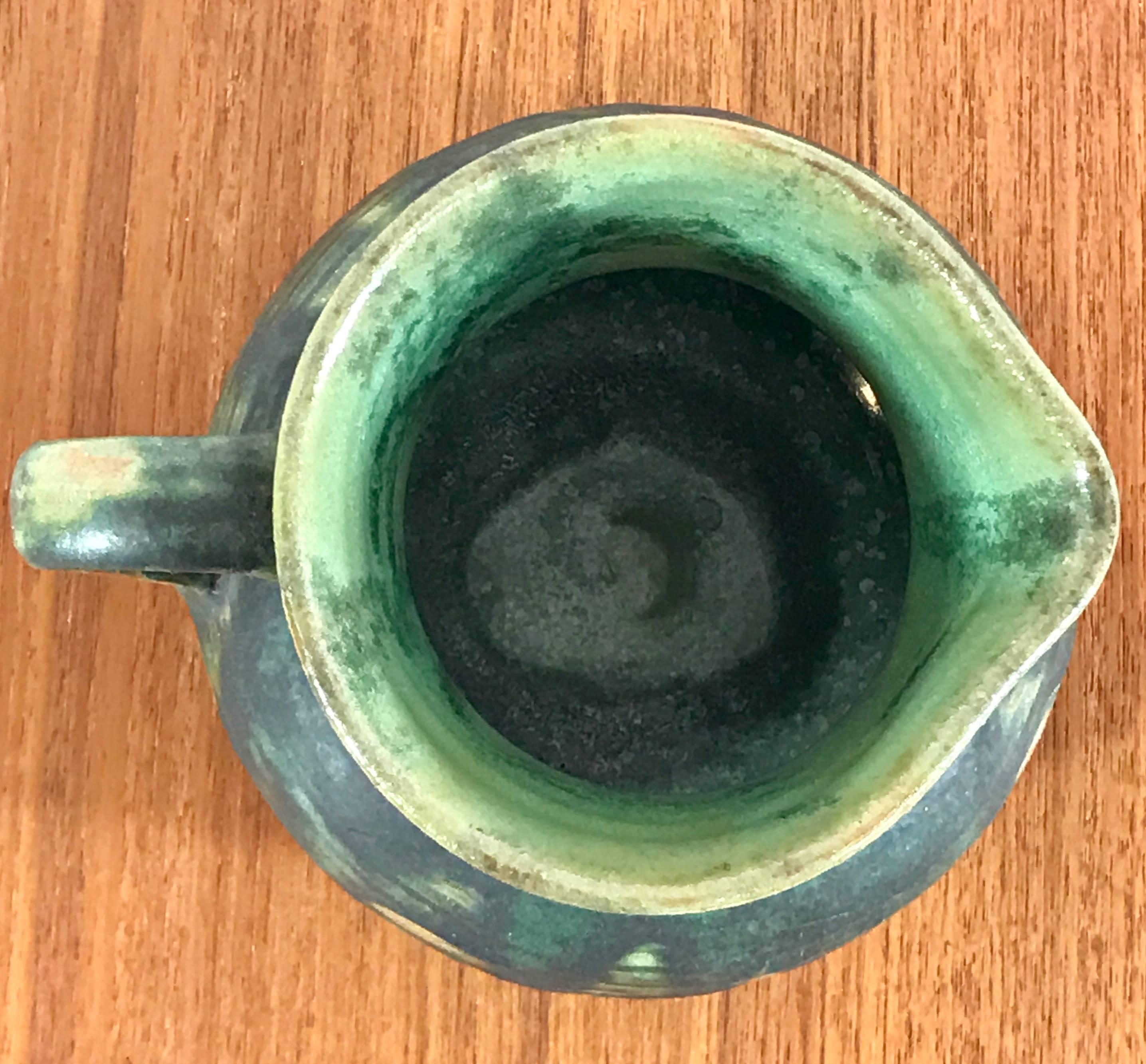 Beautiful vibrant green drip glaze ceramic pitcher. Glaze has a cool metallic shine.