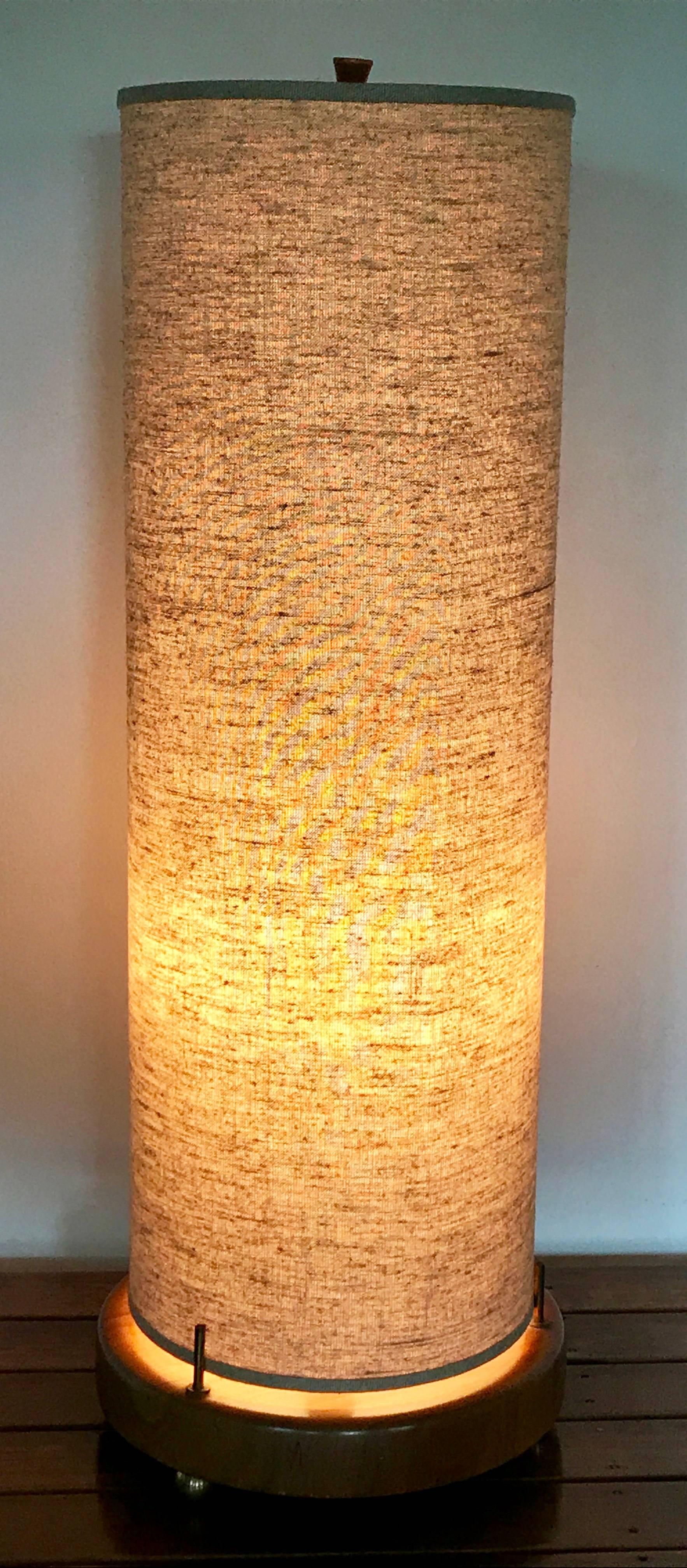 Beautiful large accent lamp in the style of Gerald Thurston with round base and brass hardware accents. Three-way switch located on top, illuminate bottom, top or both. Great original condition with no flaws in linen type cloth shade. Fine working
