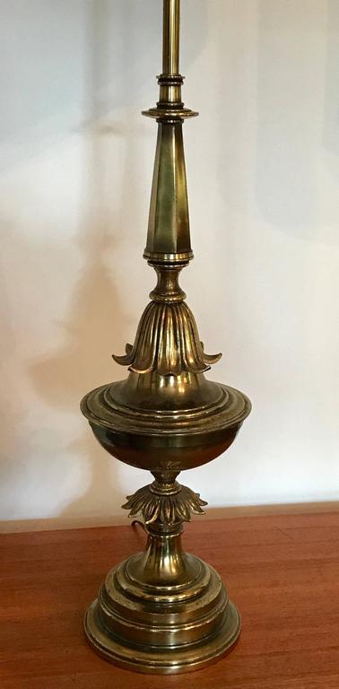 Very impressive pair of Hollywood Regency style brass table lamps. Maker unknown but very similar to the designs by Rembrandt and Stiffel Lamp Company's. Lamps left with original patina, will be professional rewired with three way switches. Shades
