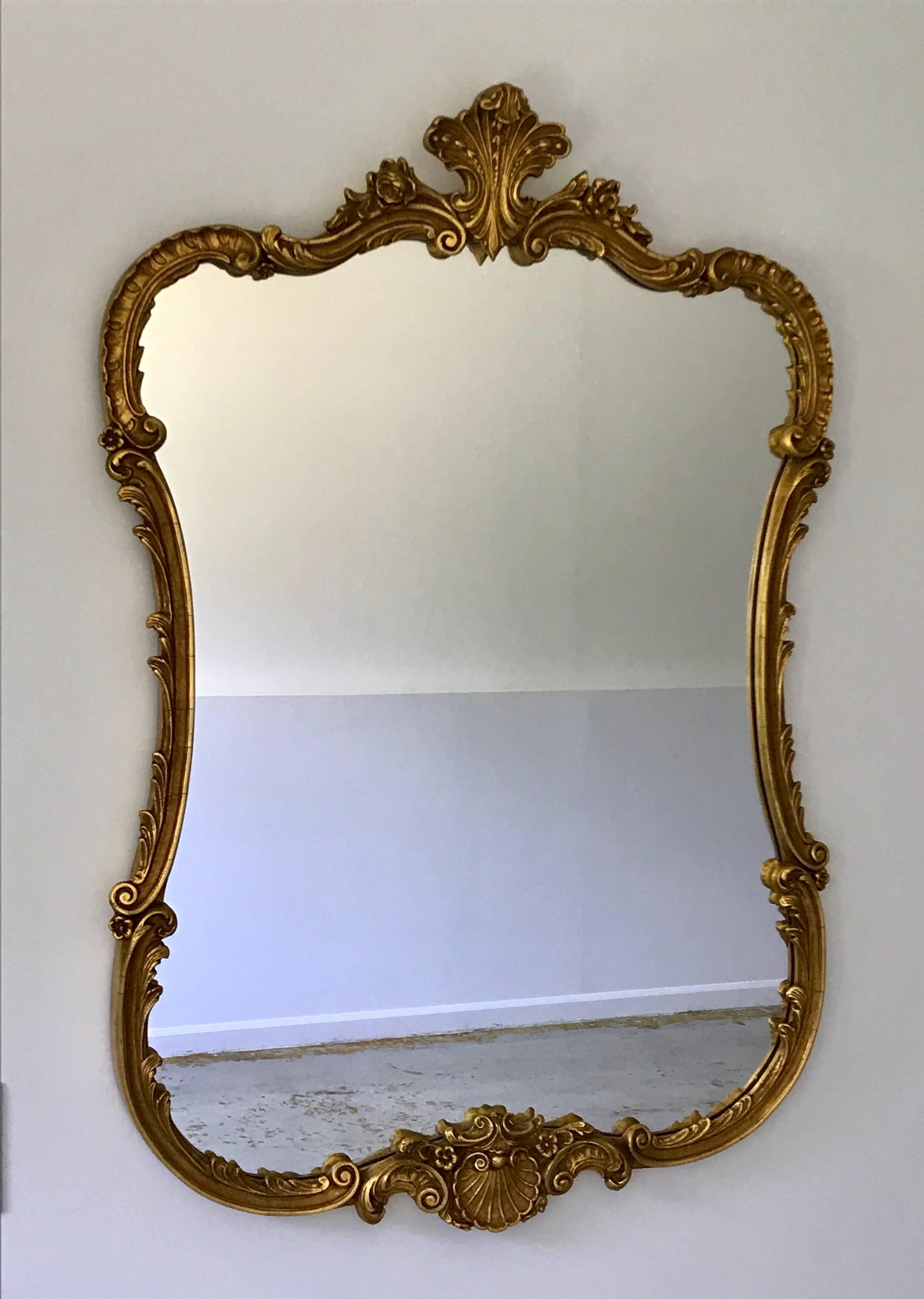 Beautiful Hollywood Regency Baroque style giltwood mirror with simple elegant details.