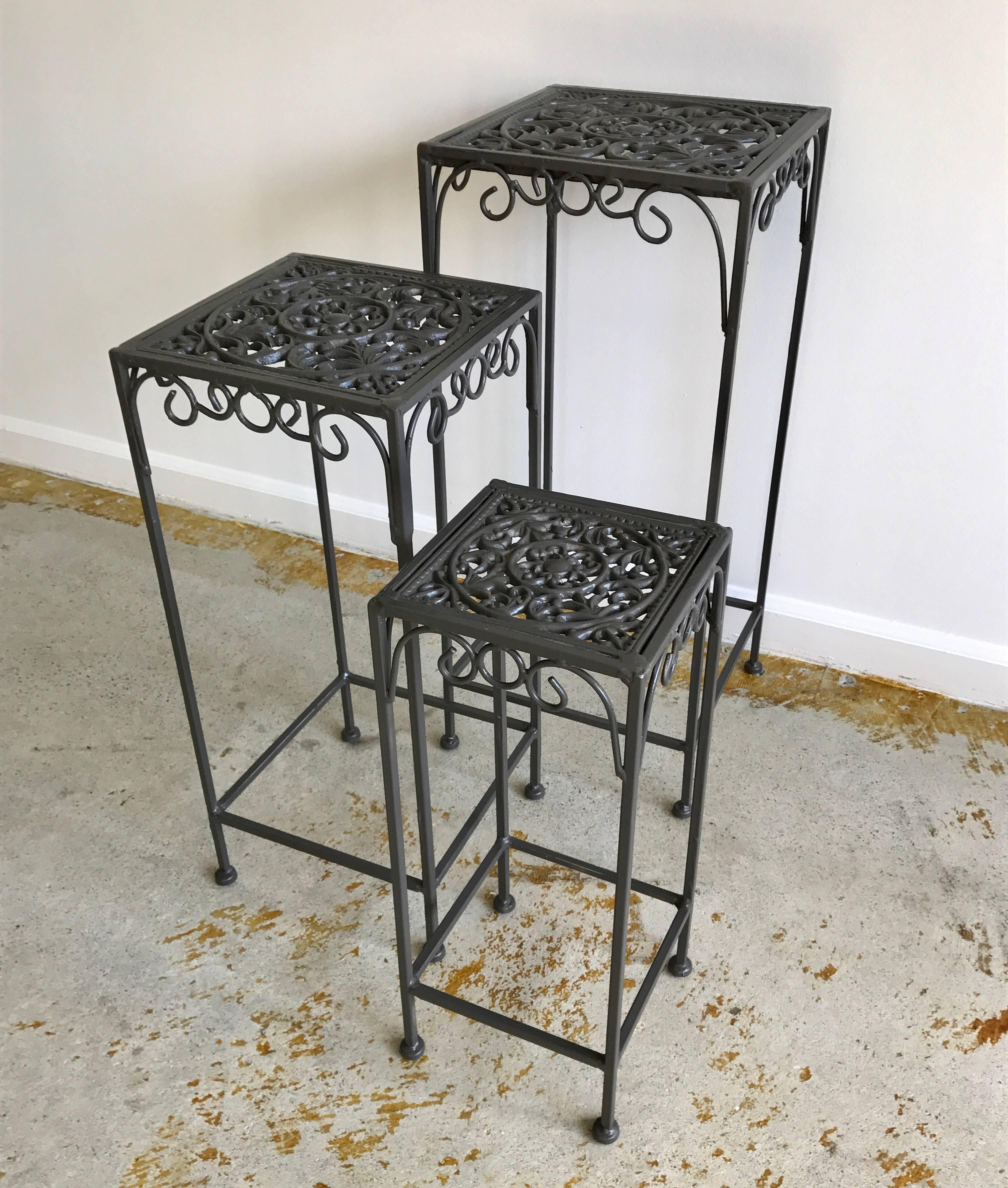 Great set of three cast iron nesting tables for your garden, patio or sun room, freshly painted, anodized bronze.

Measures: large 12 x 12 x 28
Medium 10.5 x 10.5 x 24
Small 8 x 8 x 20.