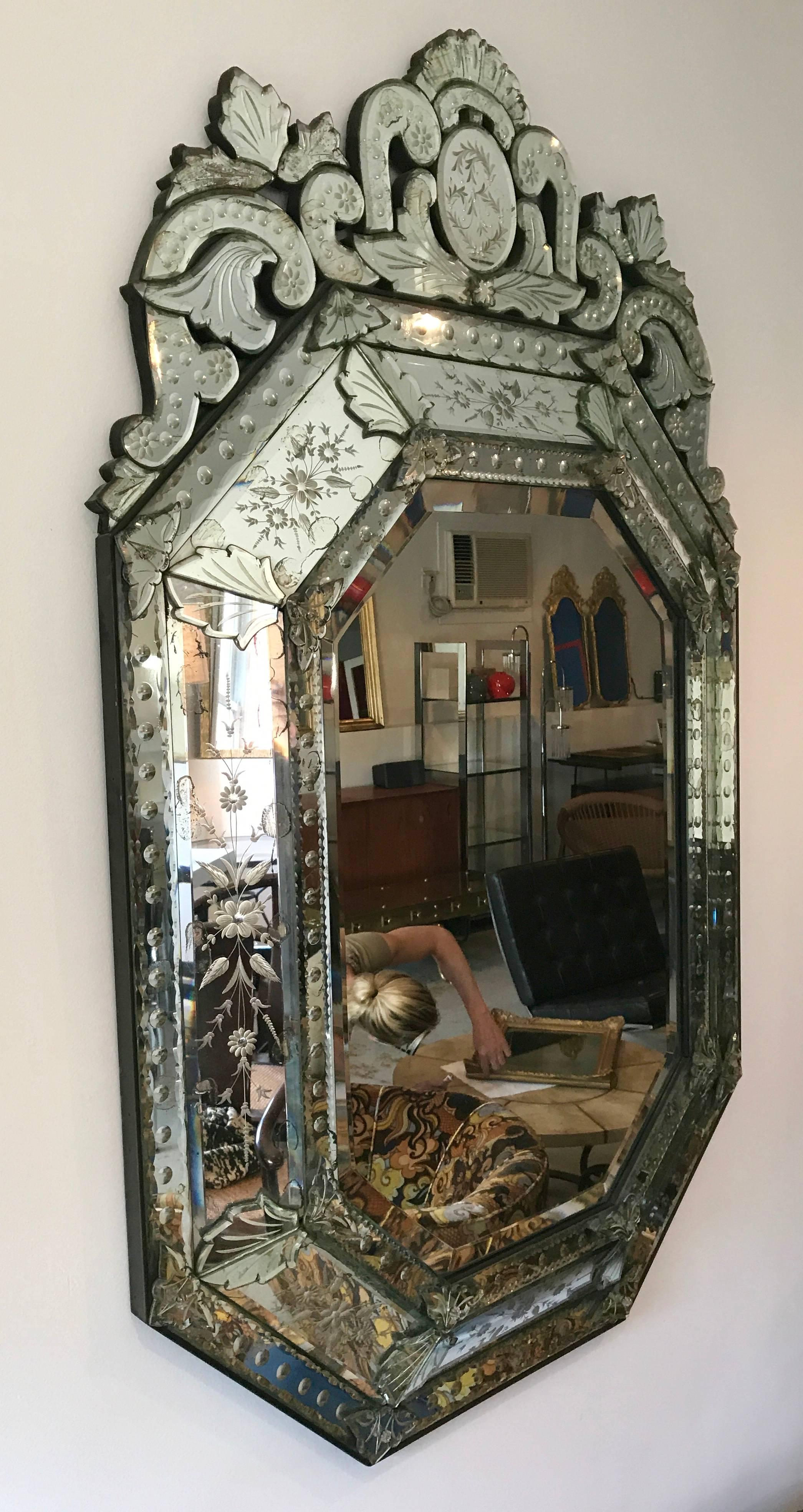 Spectacular Italian Venetian mirror with hand-carved etchings and beautiful detail. Octagon shape with crown. Old world Italian craftsmanship.