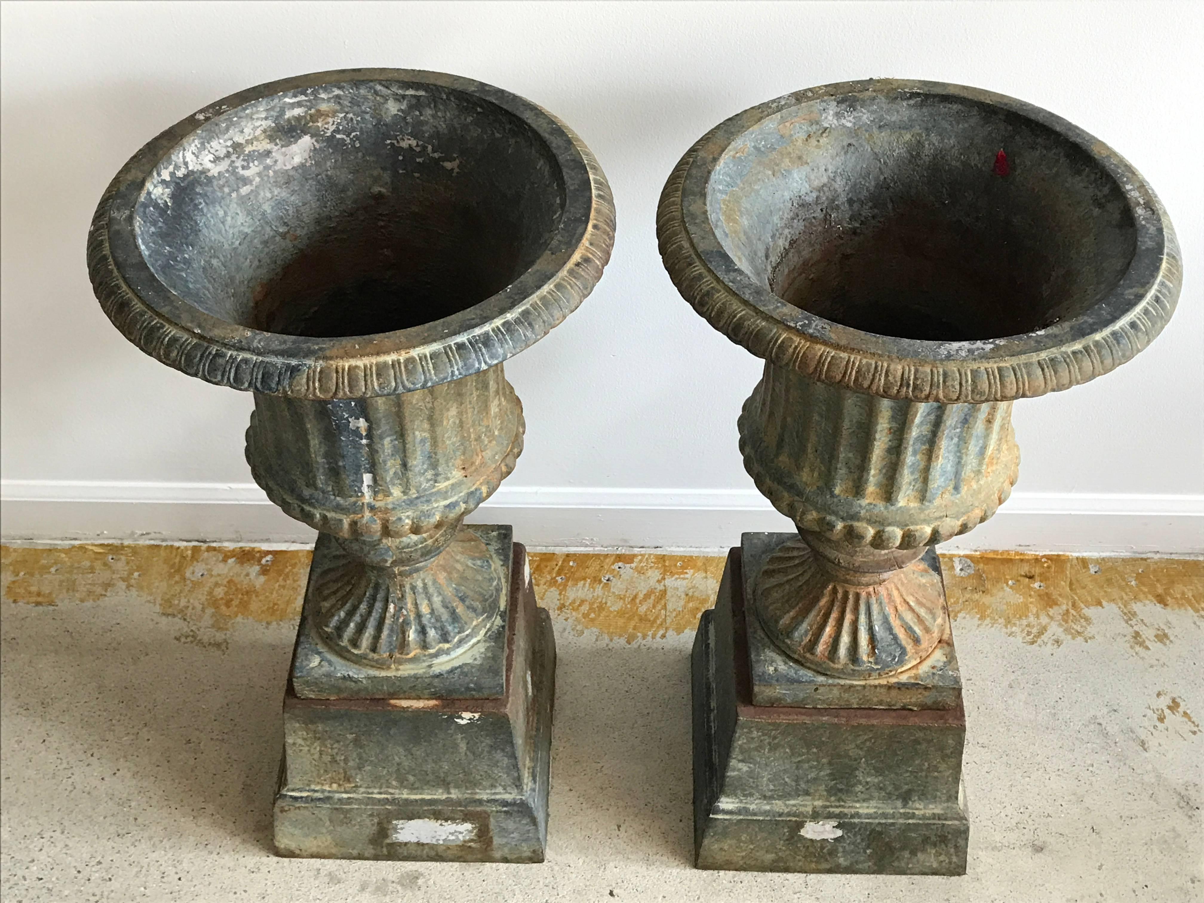 Beautiful pair of cast iron urns with original aged patina.