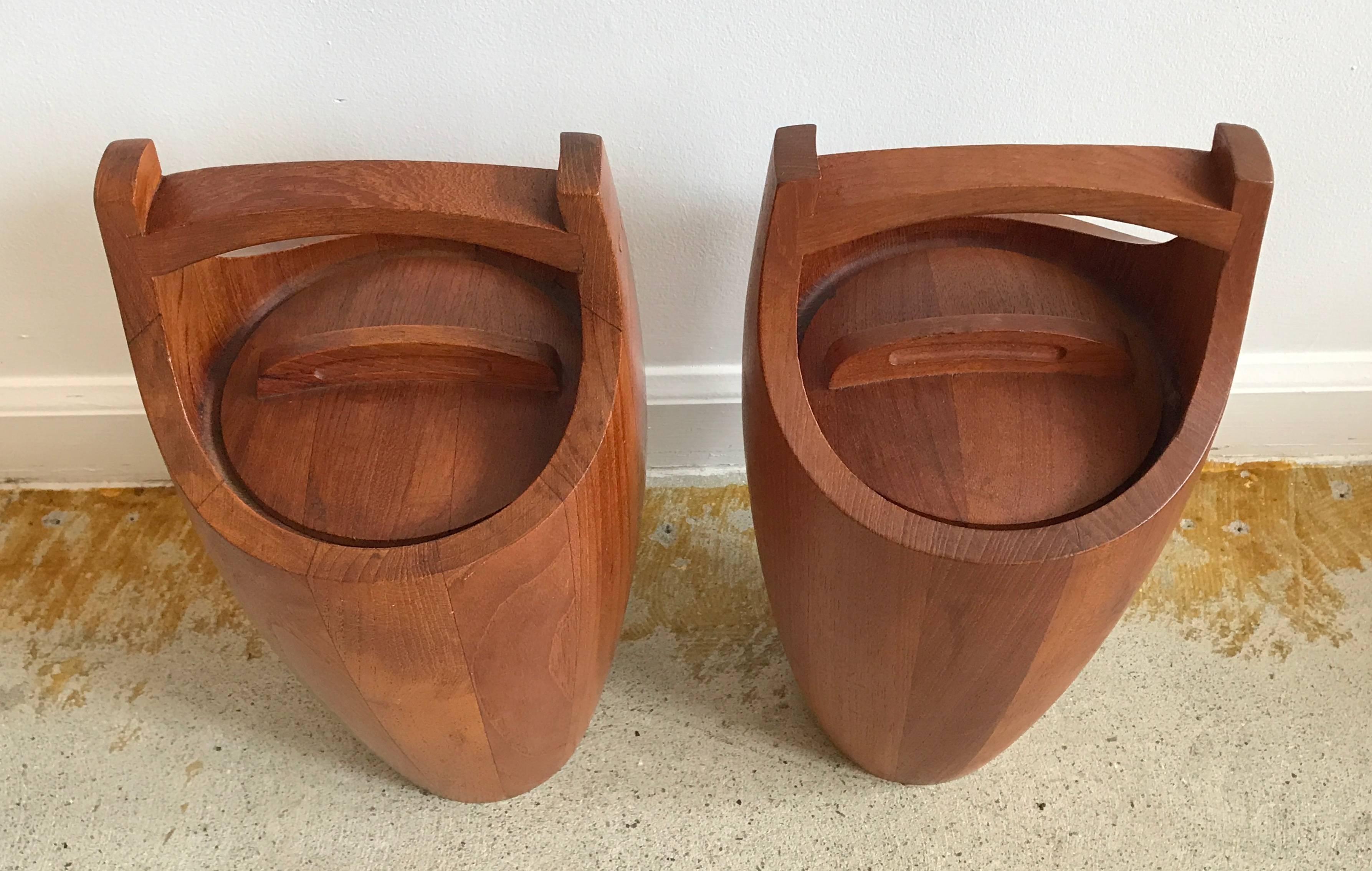 Iconic pair of teak ice buckets by Jens Quistgaard for Dansk, Denmark. One with red insert the other in black.