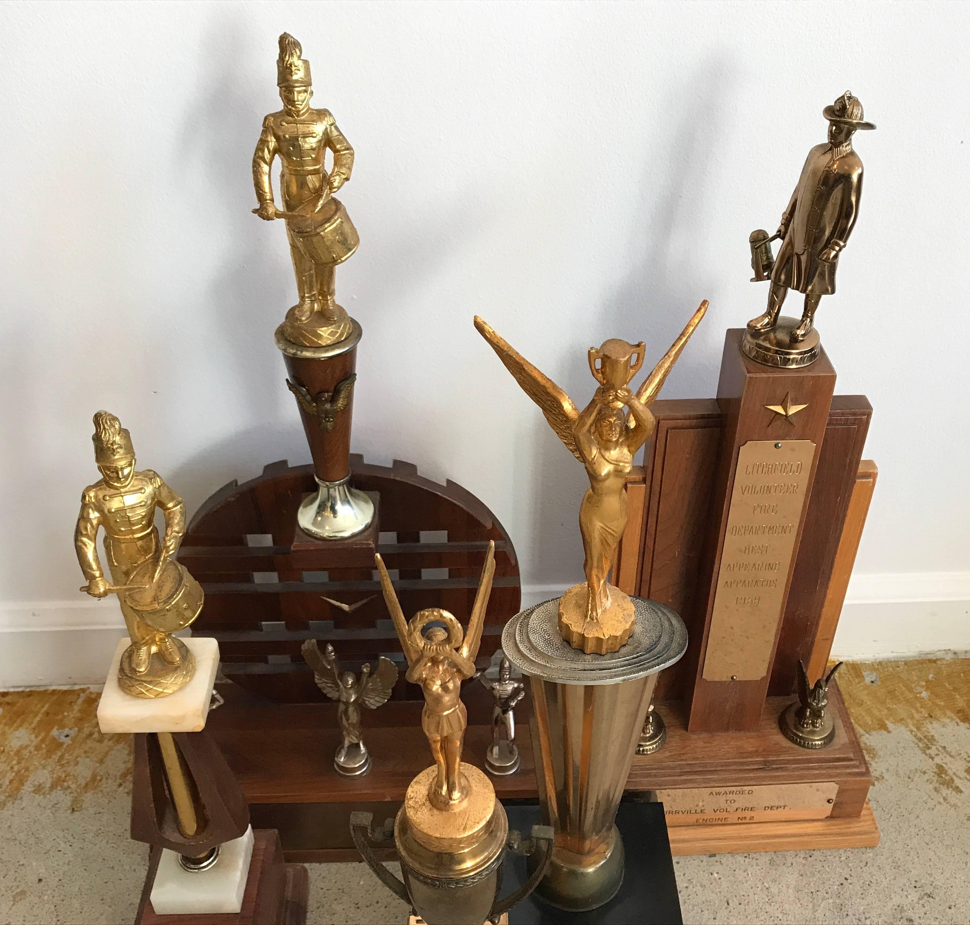 Group of vintage firefighter trophies from Litchfield CT firehouse that has since closed. All date back from the late 1950s. All wood construction and metal figurines, smallest trophy in front has bakelite sides.