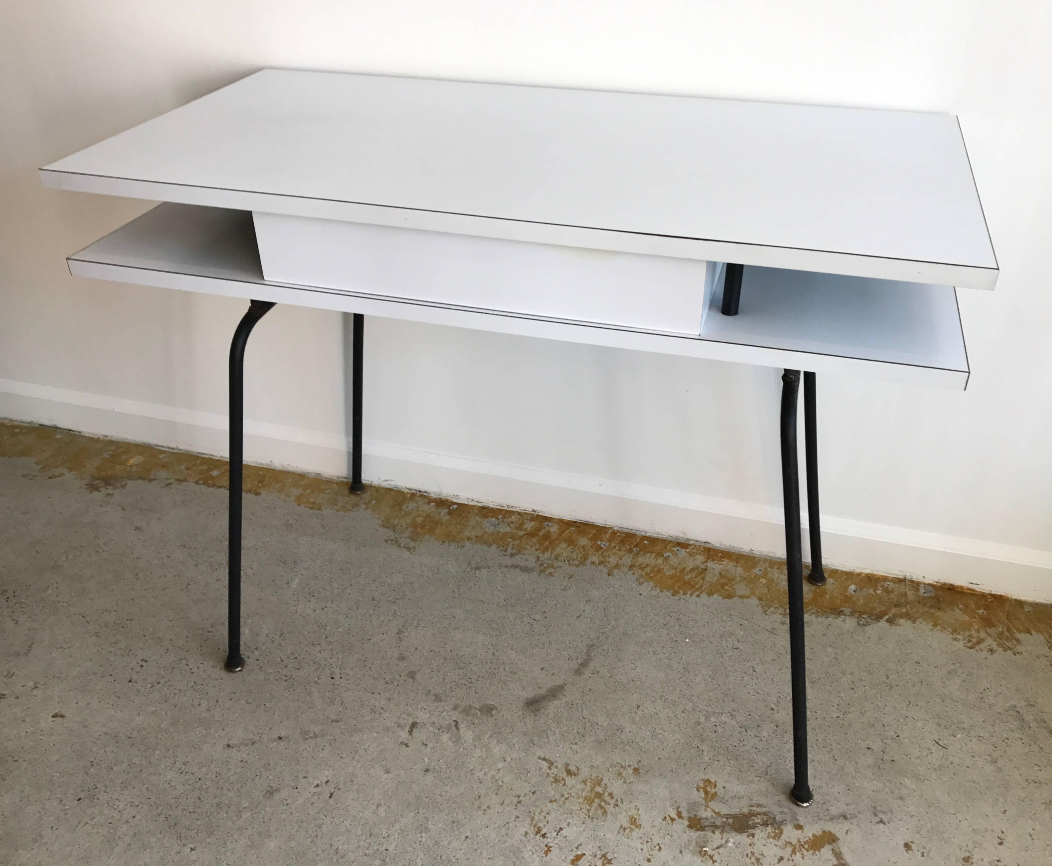 Very cool and rare Clifford Pascoe white laminate desk with one centre drawer. Formica around solid wood frame mounted on hairpin iron base.