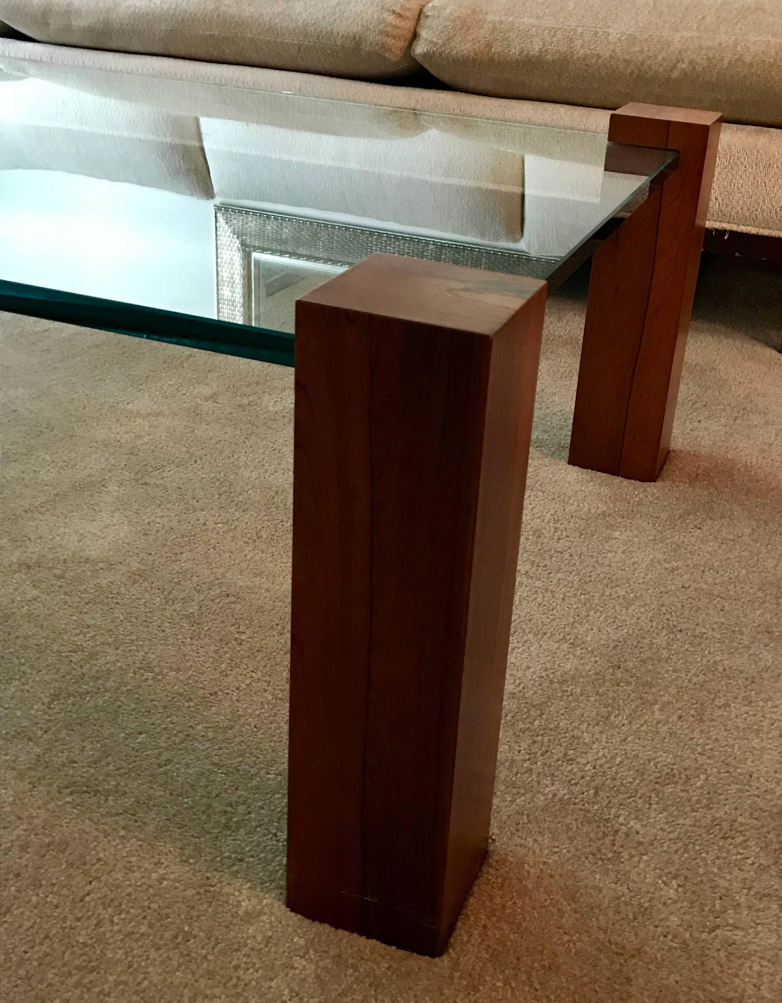 An early version in walnut of the now iconic chrome and steel coffee table by Paul Evans. Thick 3/4 inch thick clear glass rests within the walnut square towers.