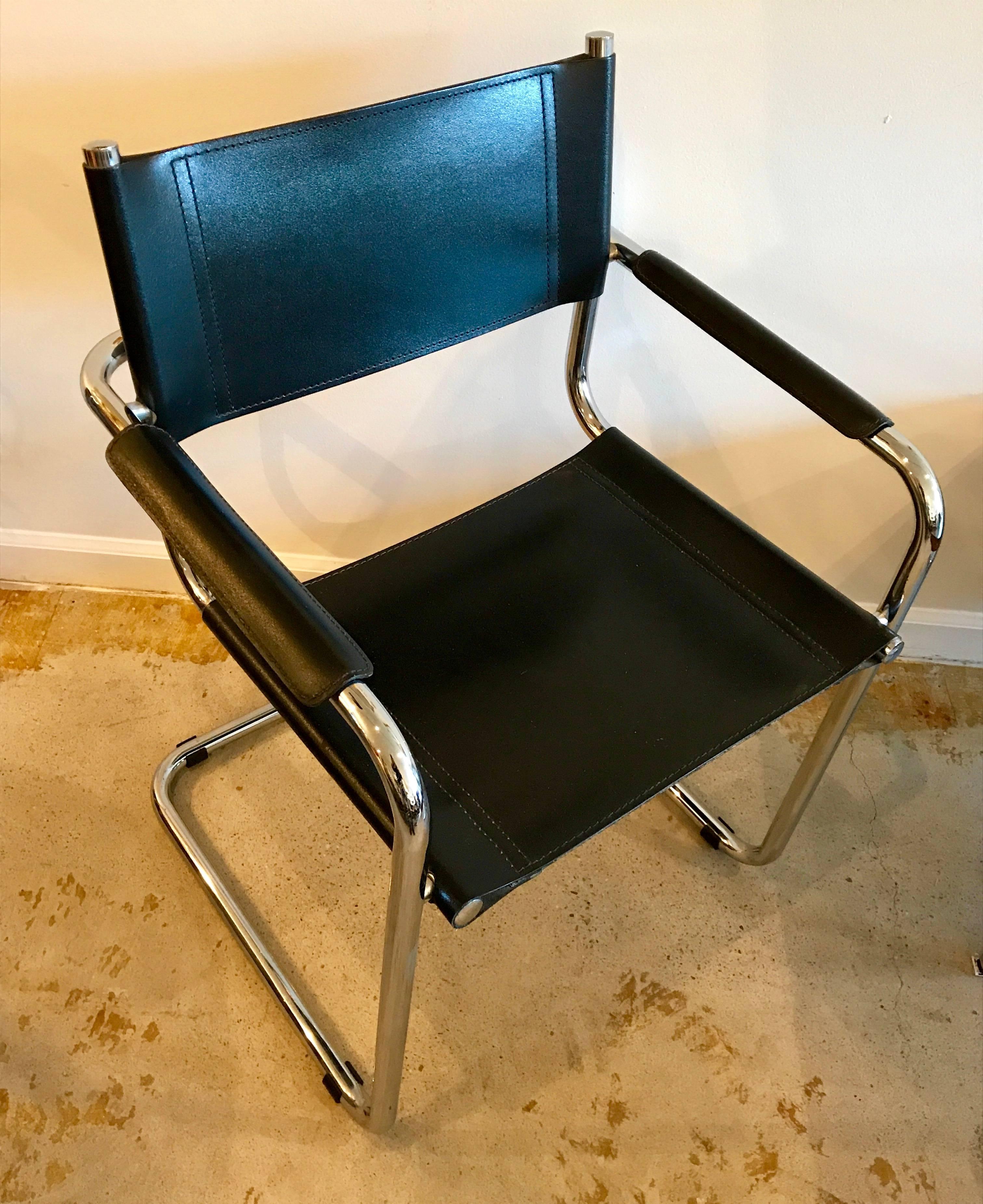 Set of four iconic cantilevered armchairs of chrome tubular steel with black leather sling seat and back and black leather armrests in near pristine condition. Designed by Mart Stam in 1927, chairs of this style were the first cantilevered chairs in