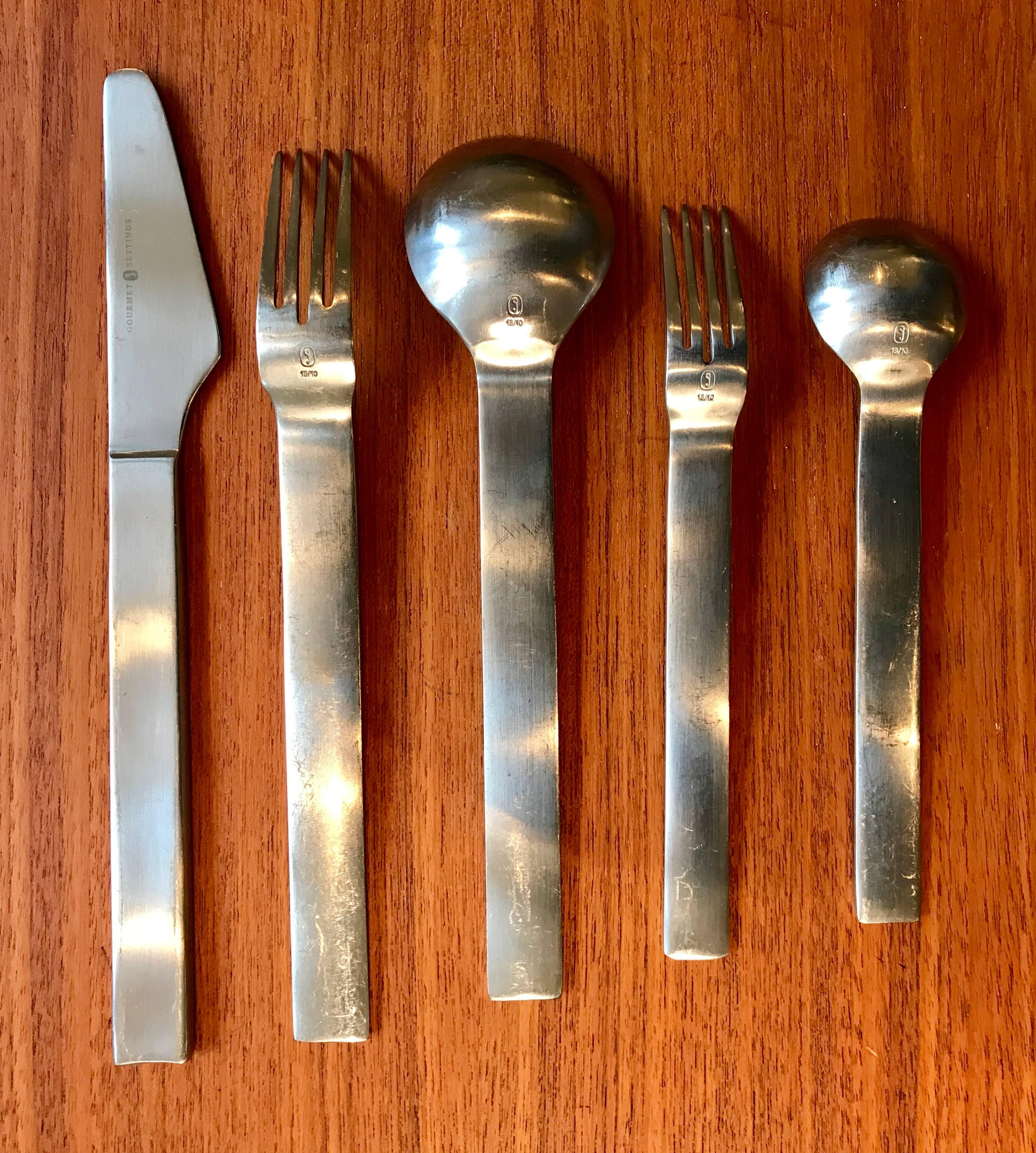 Set of stainless steel flat wear manufactured by Gourmet Settings. Great simplistic Mid-Century Modern design and shape. All pieces are structurally sound and straight, but have surface wear due to daily normal use.