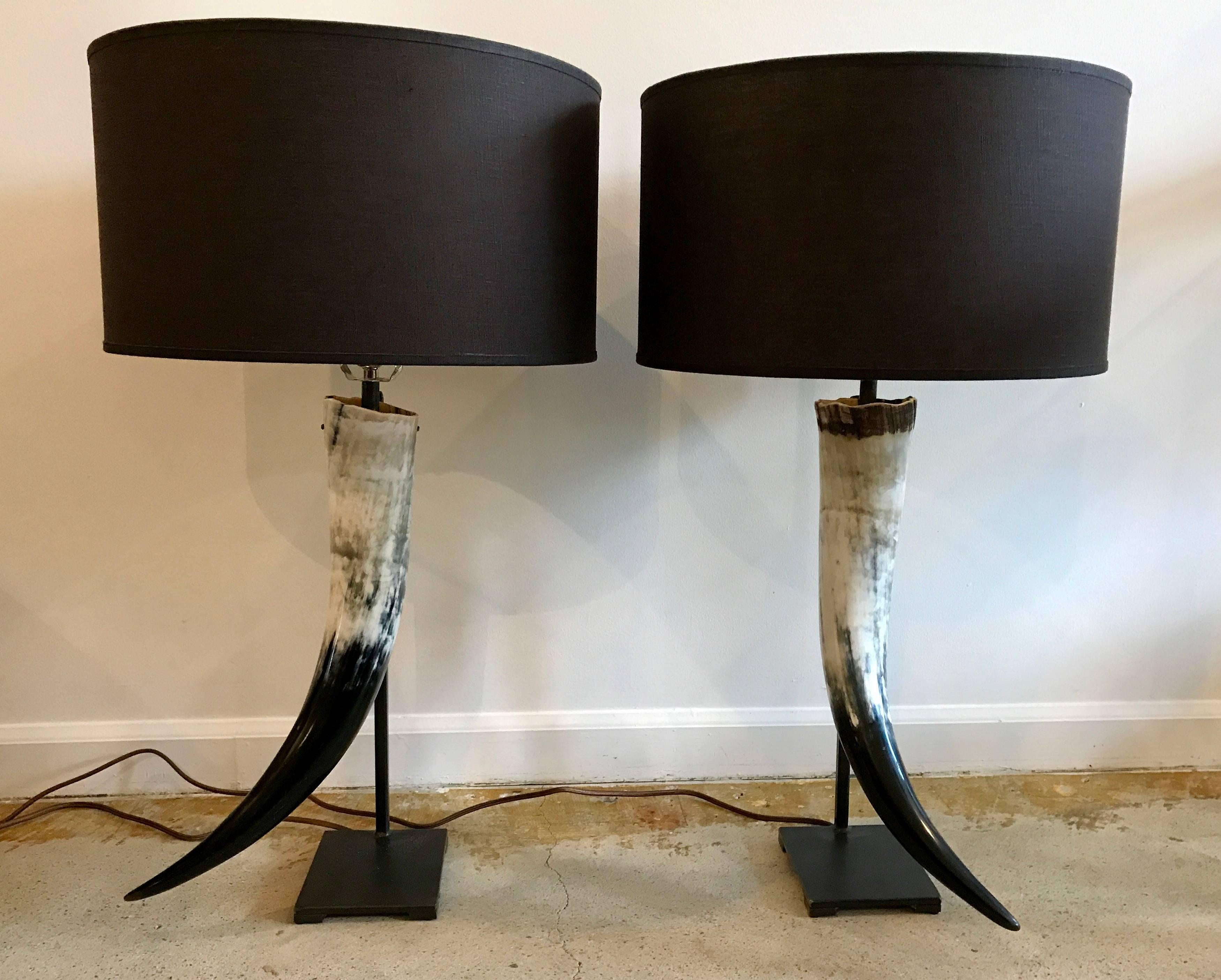 Fantastic contemporary pair of authentic Texas Longhorn table lamps, artisan crafted. Beautiful black and white horns mounted on blackened steel bases. Rewired with three-way sockets.