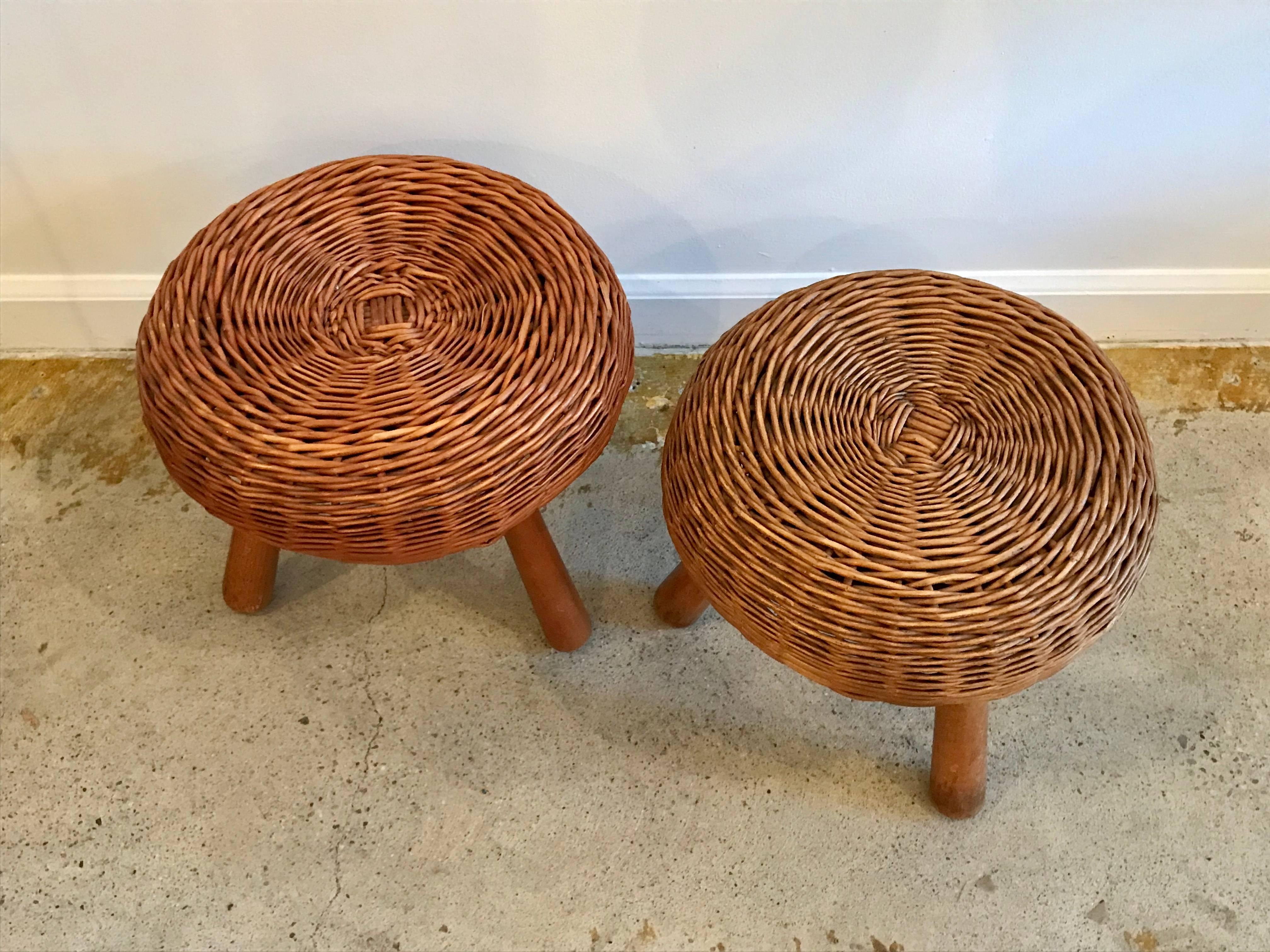 Tony Paul round woven rattan / wicker footstools with tripod legs.