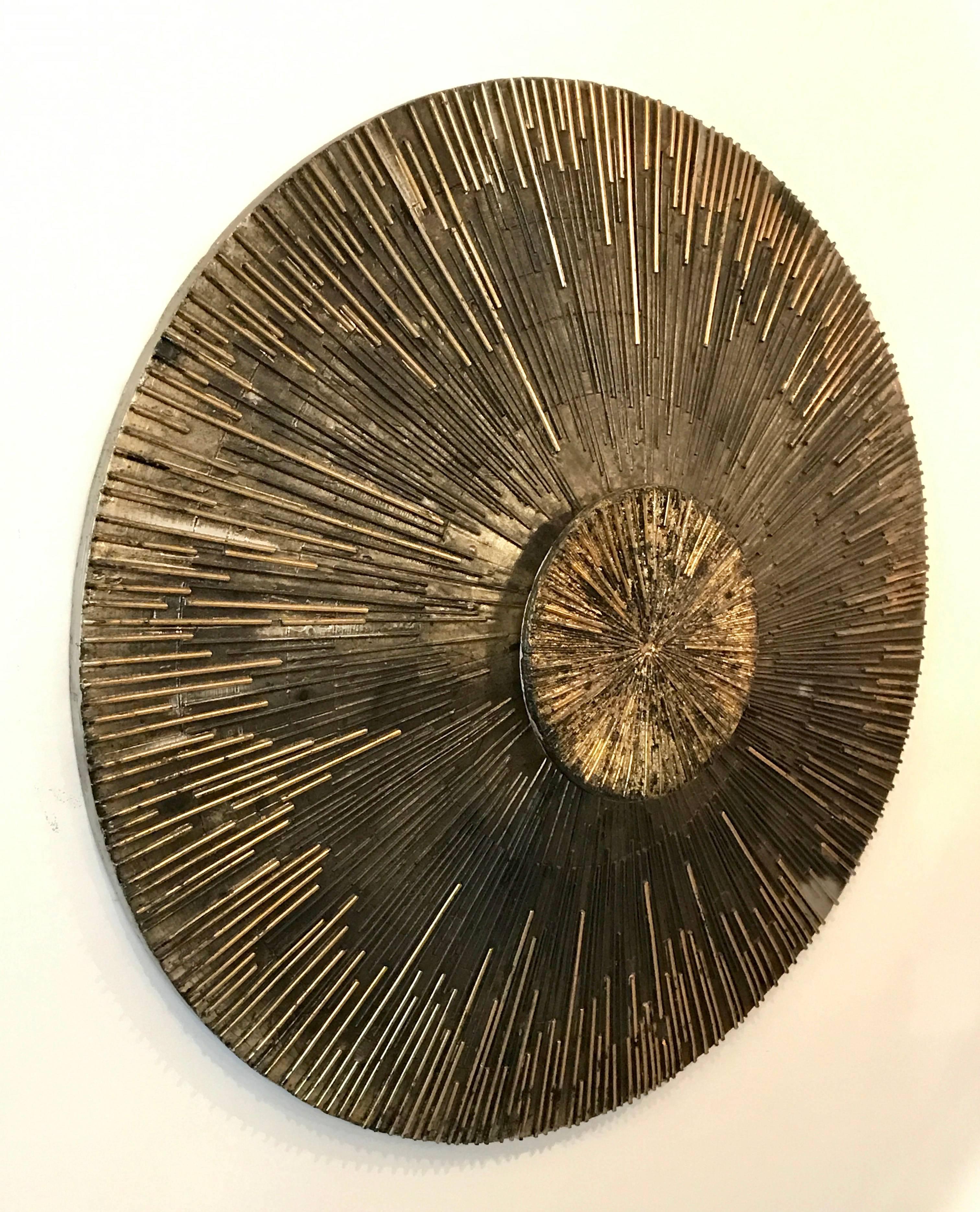 Very cool massive round brutalist wall sculpture made of fiberglass, hand painted in layered metallic, earth tone colors with bronze, silver and gold.