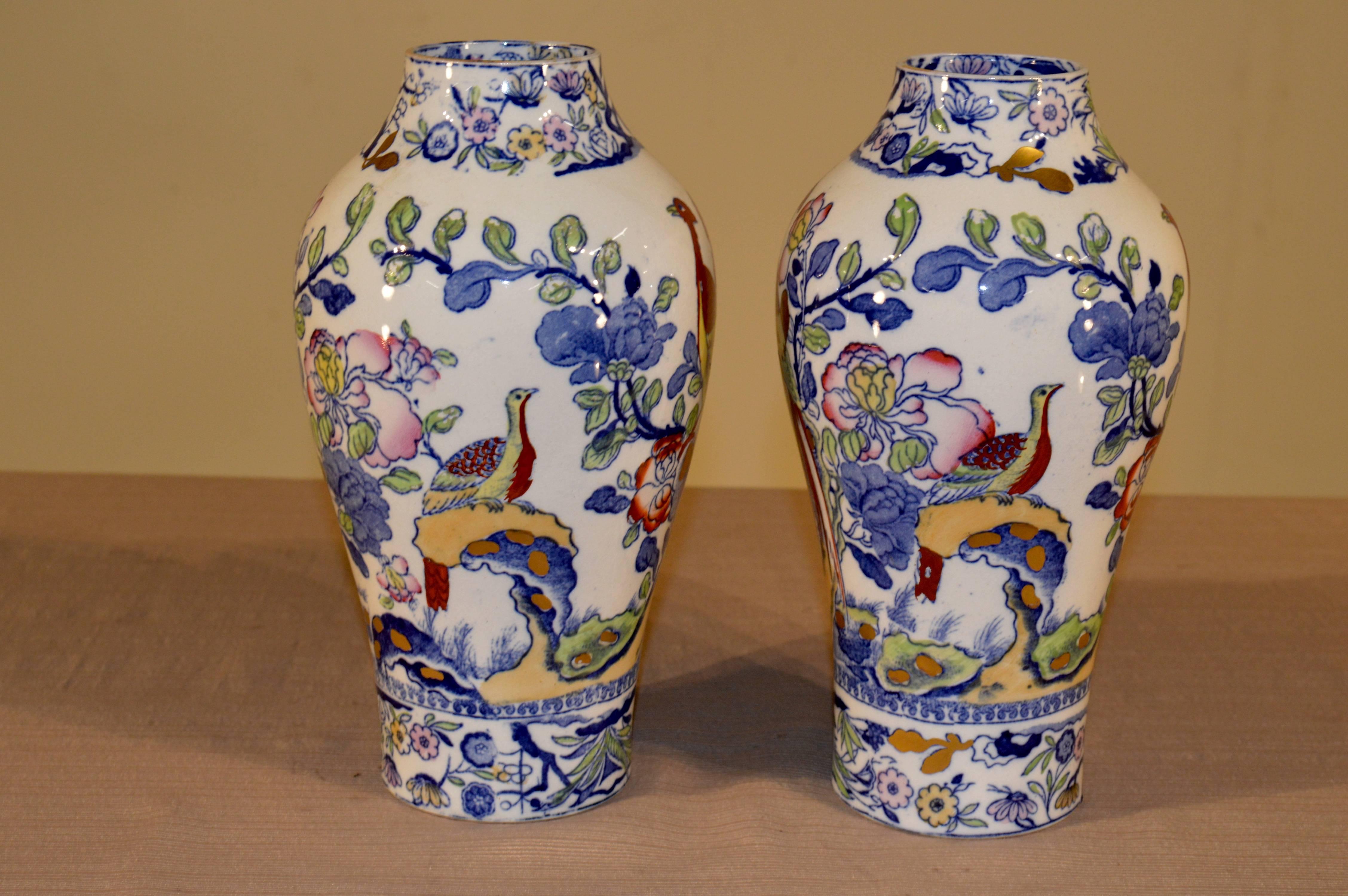 19th century pair of vases signed by Mason's. The vases are transfer pattern with birds and flowers and have hand-painted decoration as well. There are slight losses to the painted decoration. Beautiful coloring and form.