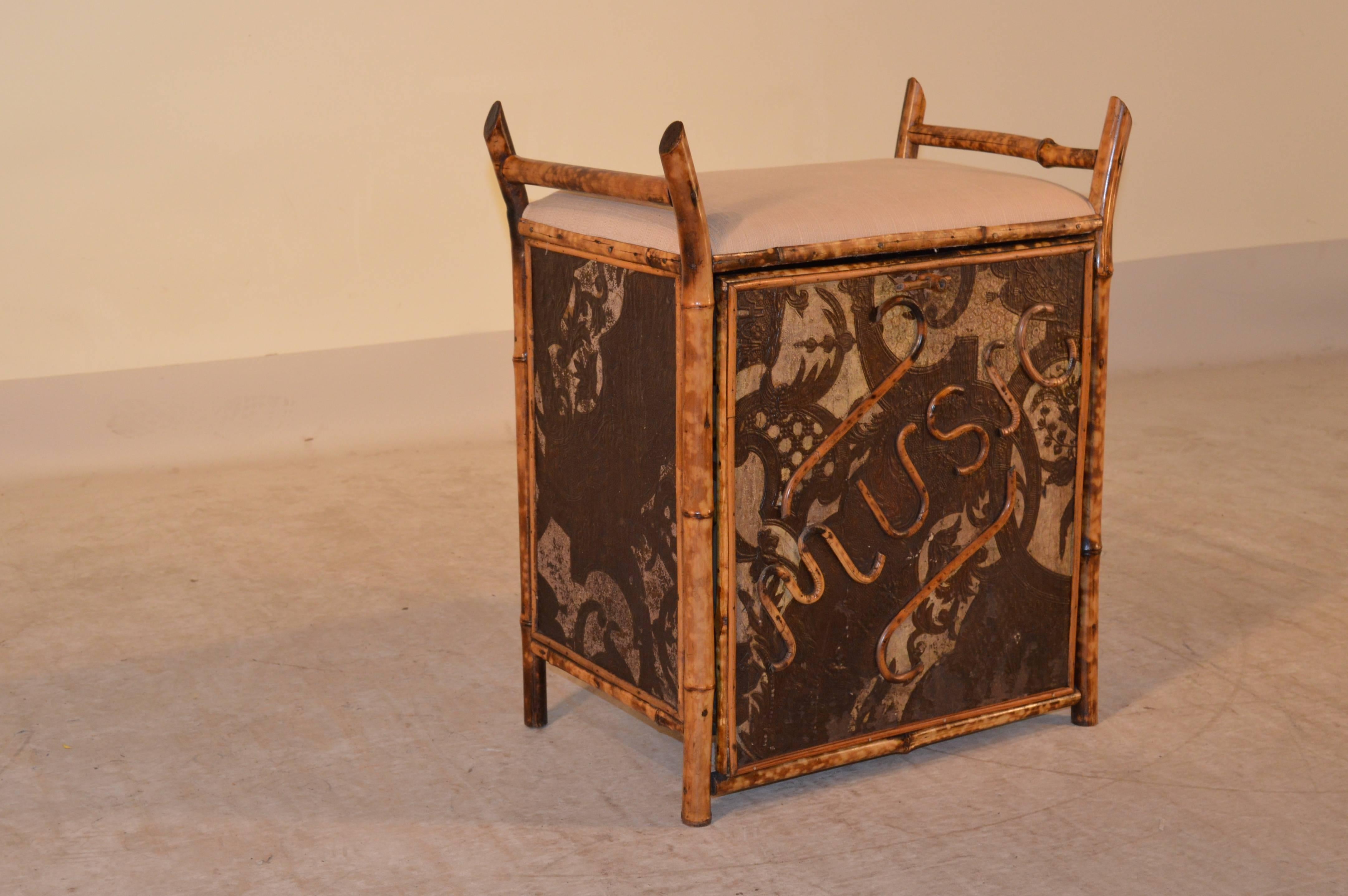 19th century English bench which has a pull-out music door with sections for sheet music. The piece is wonderfully constructed of tortoise bamboo and is in lovely condition. The seat height is 20.75