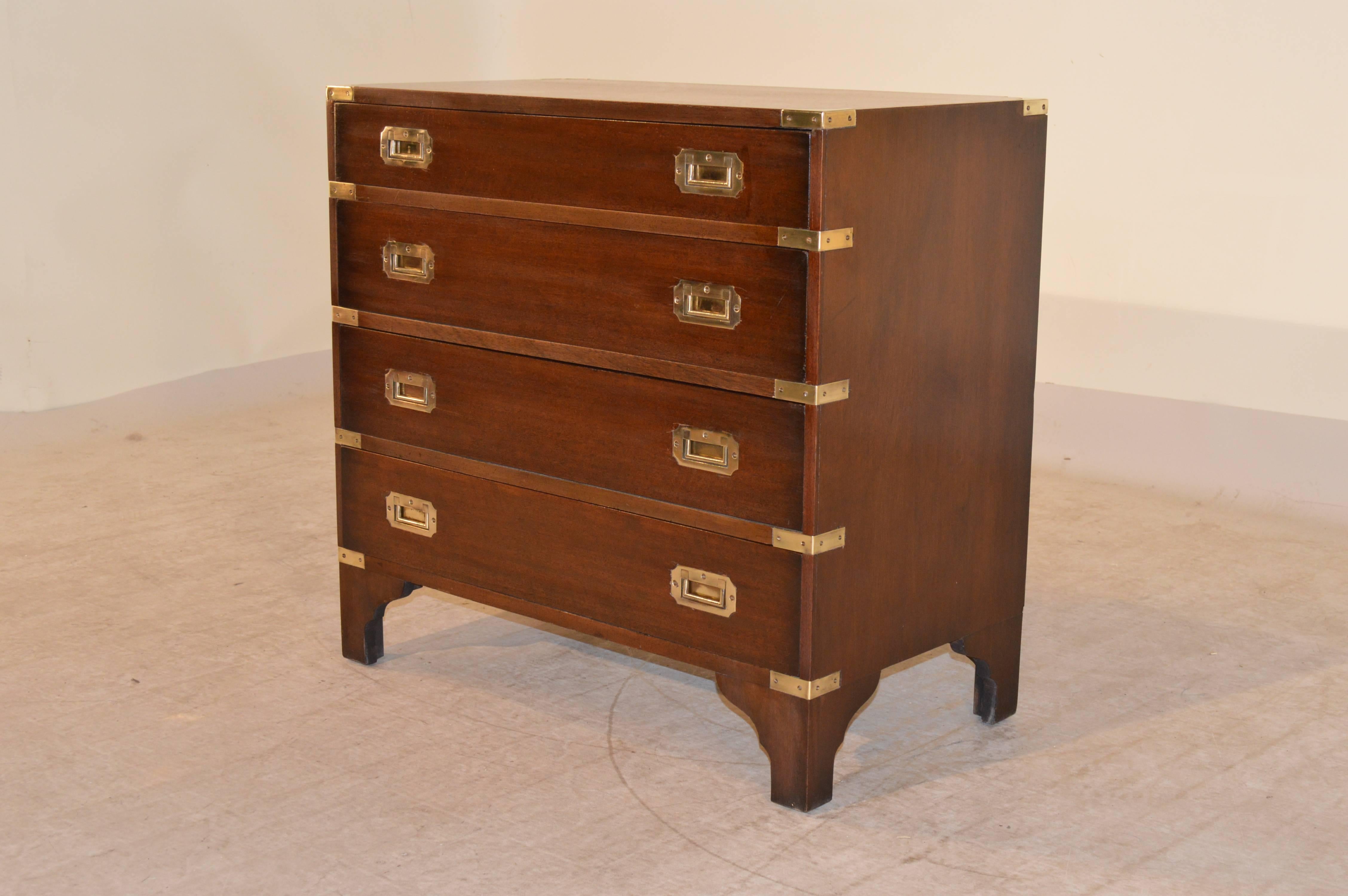 English Campaign style chest made from mahogany with brass accents and hardware. It has four drawers and is raised on bracket feet, circa 1950.