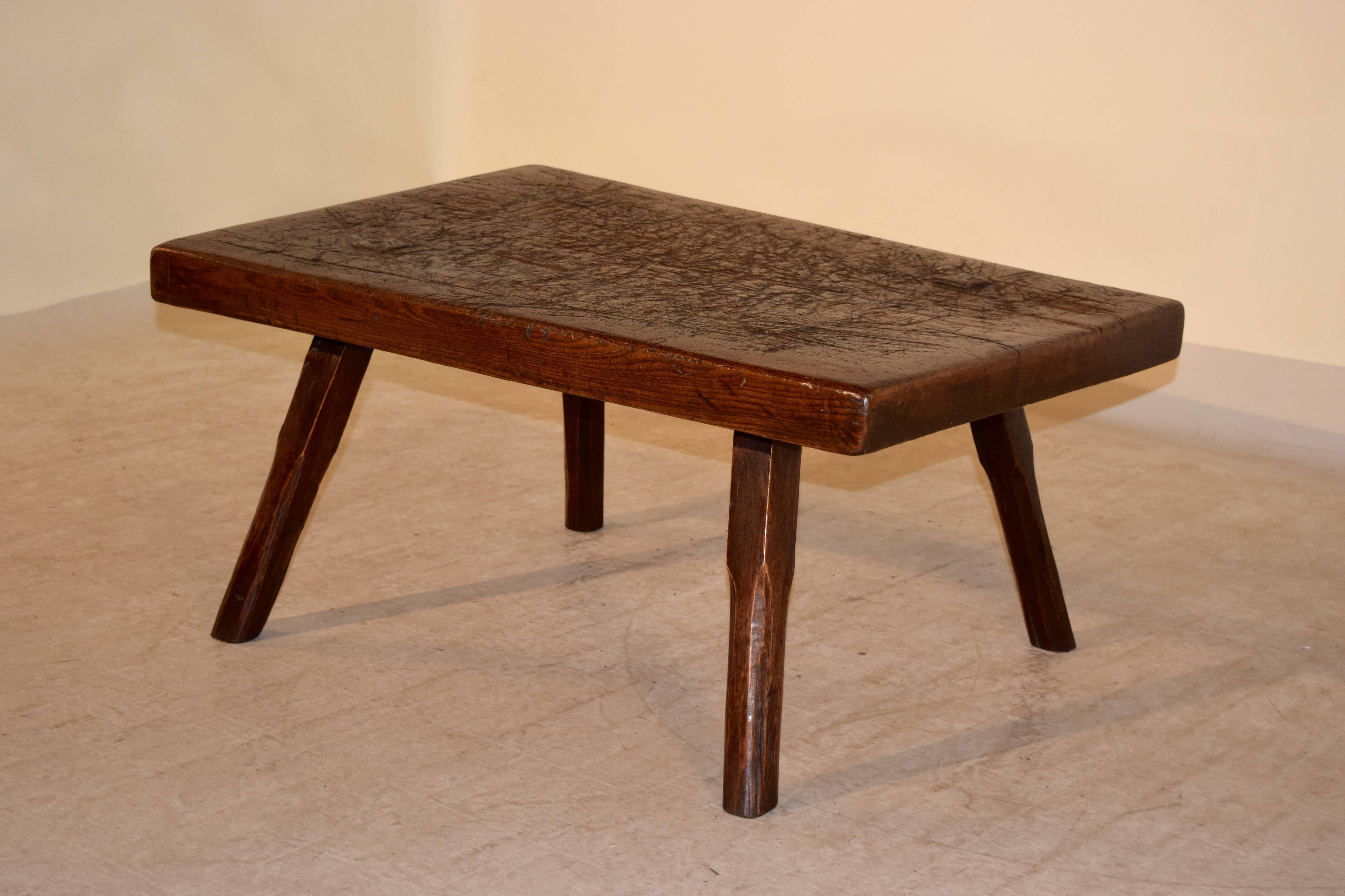Mid-19th century English large choosing block, which has had legs added to make it into a coffee table. The top is a solid block and has multiple old cuts and scarring from actual use. The pegging is a wonderful detail to see.