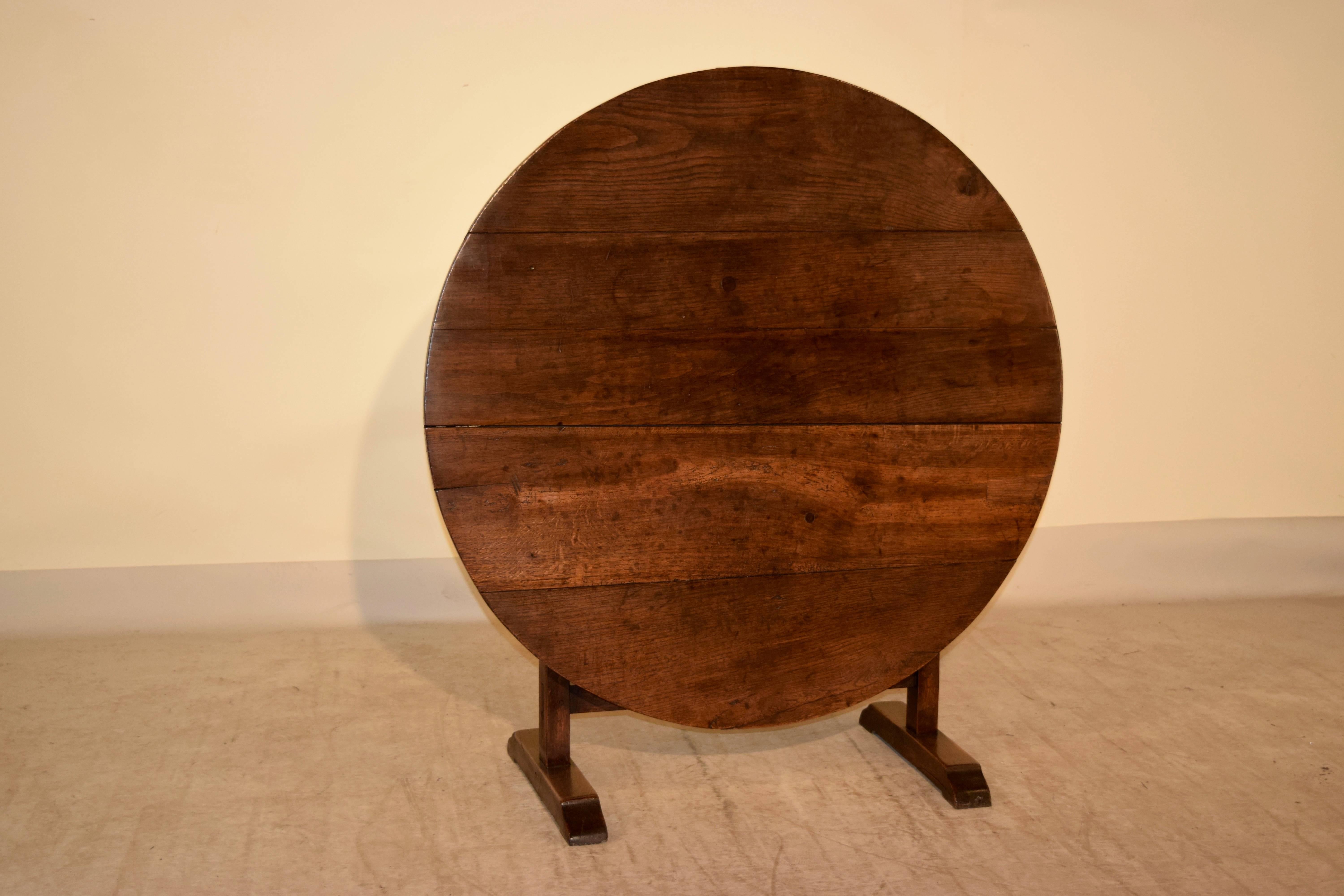 Mid-19th century wine-tasting table made from oak. The top is made up of four planks and is supported on a V-shaped trestle base. When open, the top measures 42.5 W x 42.13 D x 27.5 H.