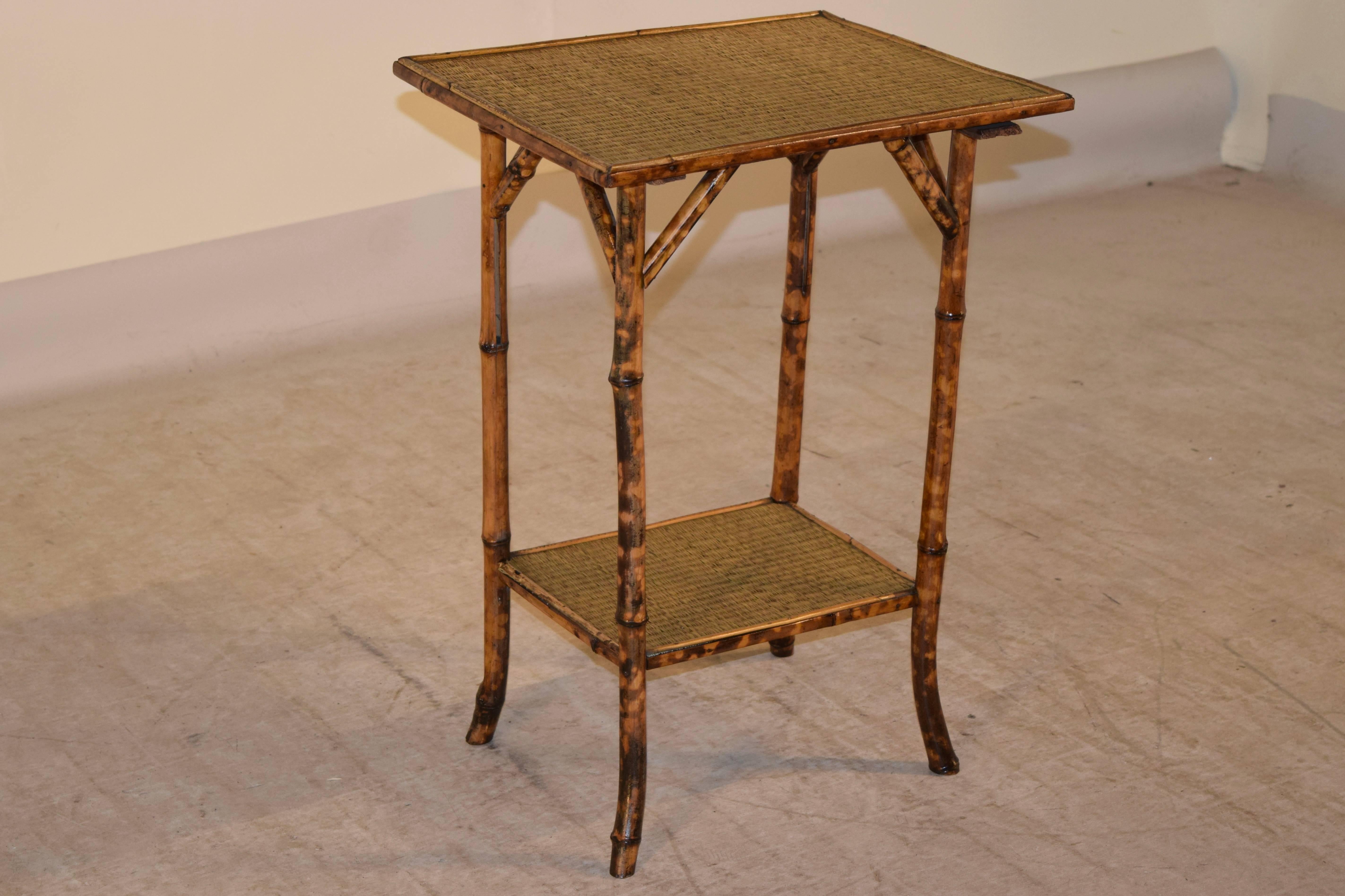 Late 19th century French side table made from tortoise bamboo. The top and lower shelf is covered in rush.