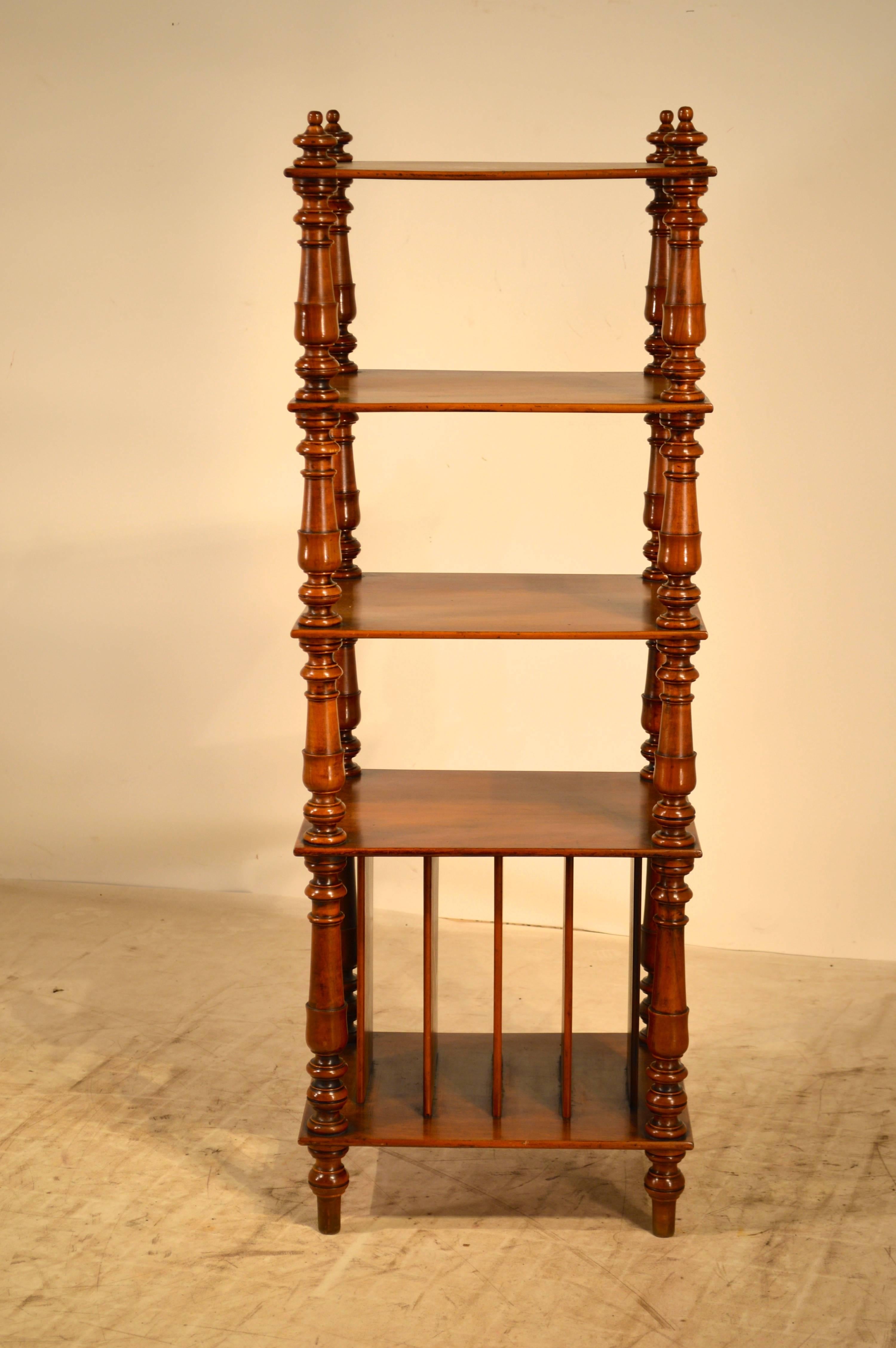 19th century English mahogany standing shelf with turned shelf supports and music shelves on the bottom shelf.