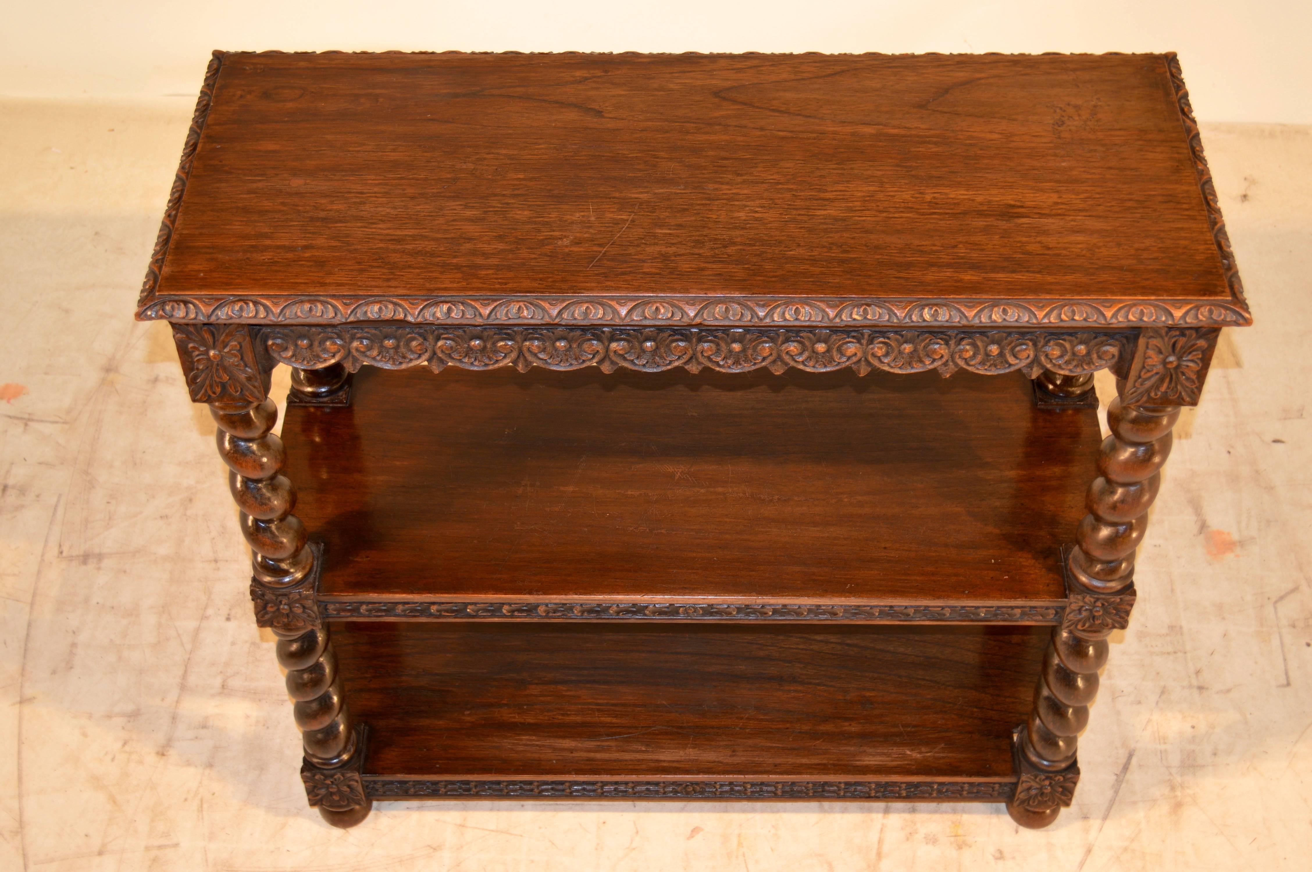 19th century English book shelf with a beveled and gadrooned edge around the top and a carved apron which is on both sides for easy placement in any room. The front of the shelves are carved, and the shelves are separated by thick turned