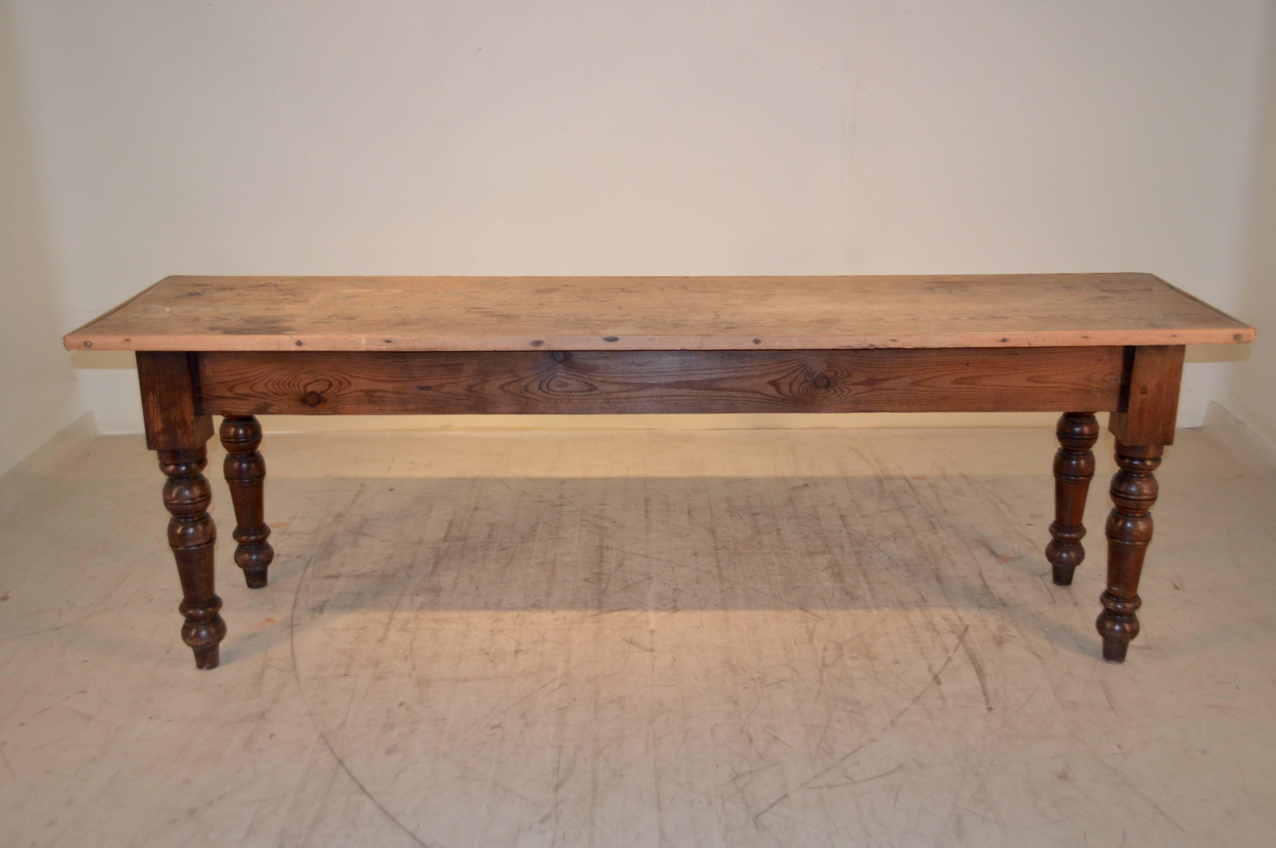 19th century French baker's table made from pine. The top is two plank and has a banded edge following down to a simple apron and nicely turned legs. The table has been used well and has signs of wear and use on the top. Shrinkage, losses to banding.