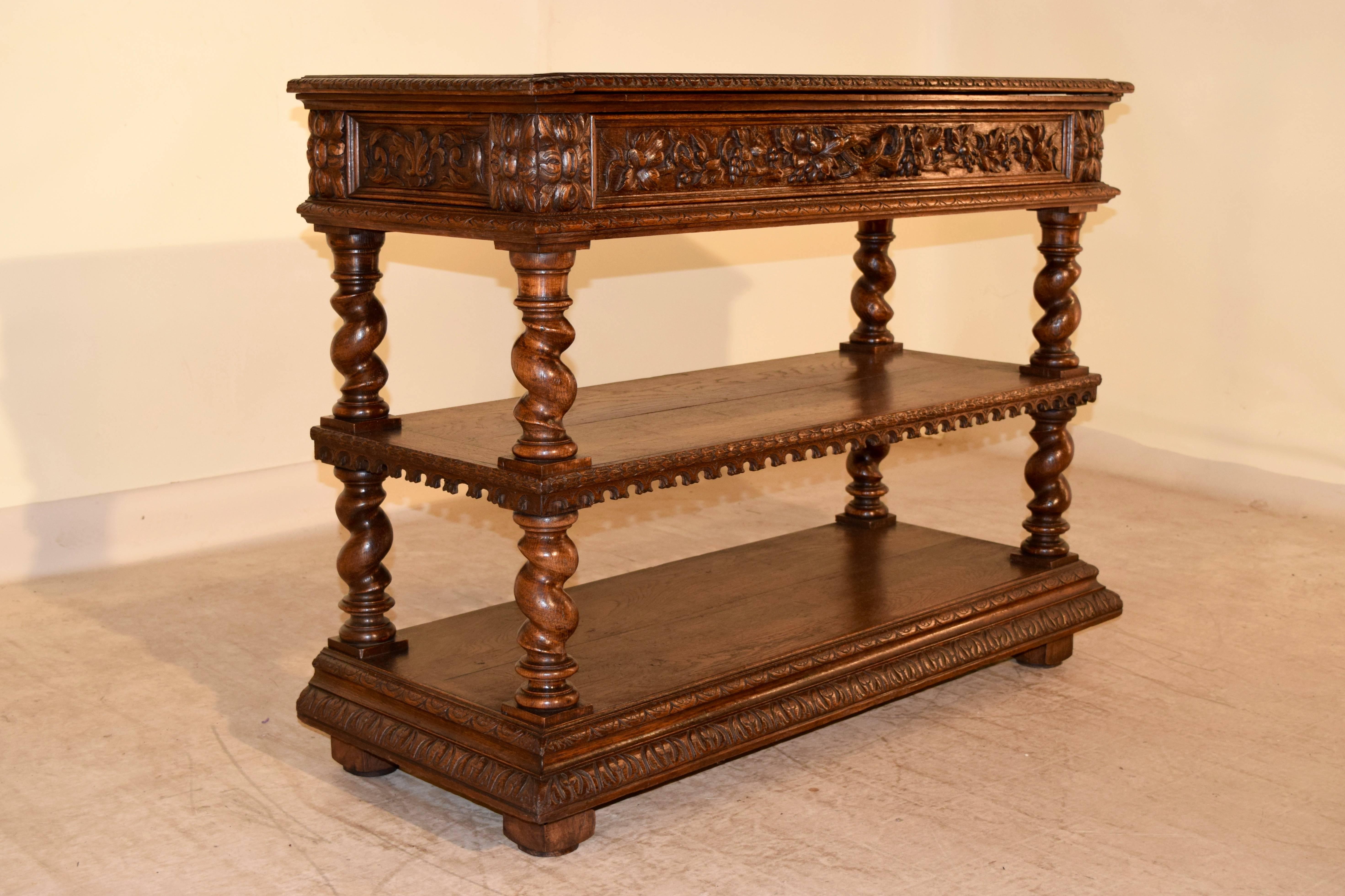19th century French dessert buffet with a beveled and gadrooned edge around the top, which also is hinged and lifts to reveal a wood serving surface. The apron has hand-carved panels with leaves and grapes on the sides and drawer front, and also has