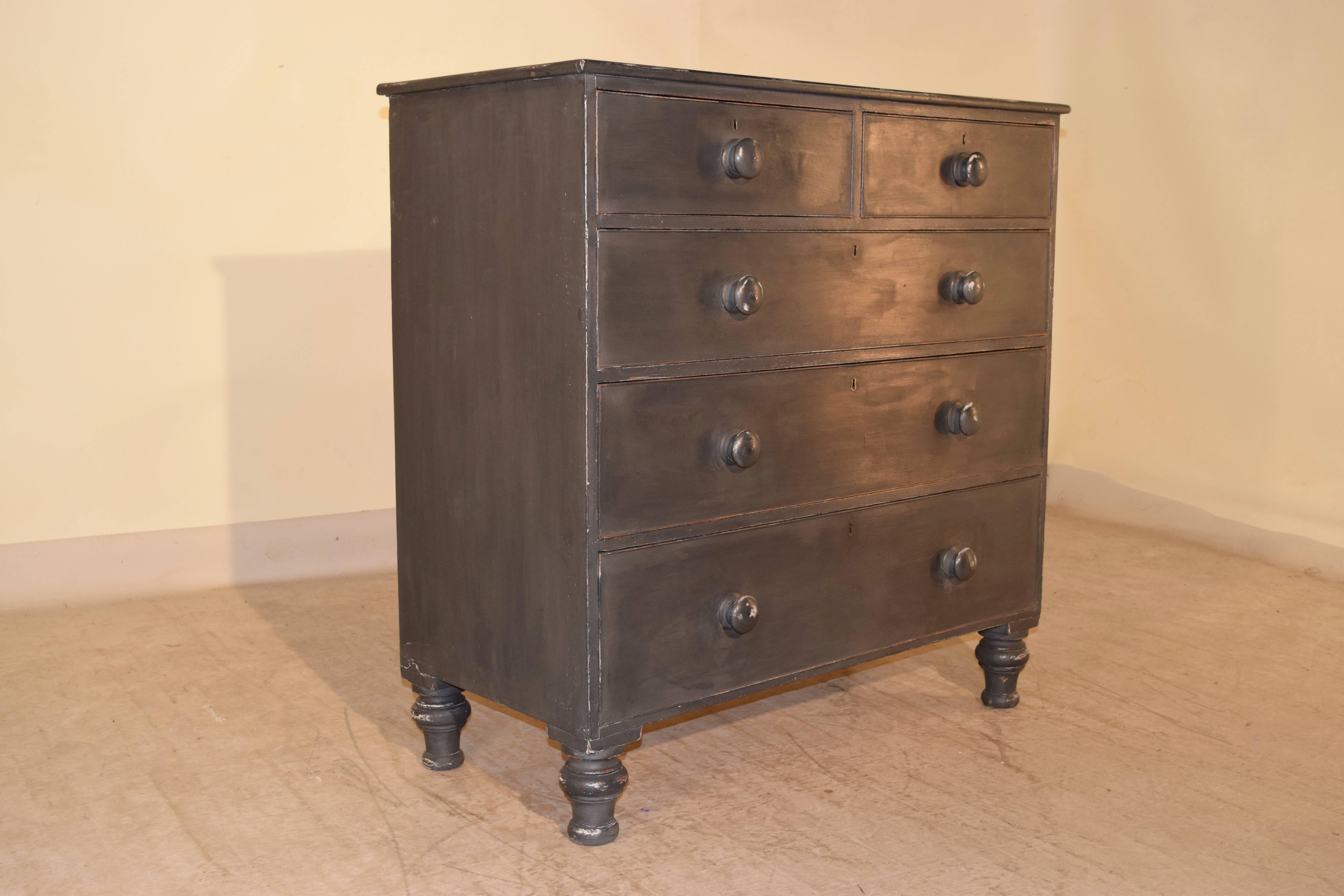 19th century English chest of drawers made from mahogany and painted in charcoal gray. The top has a beveled edge and follows down to two drawers over three drawers. It is raised on hand turned feet.