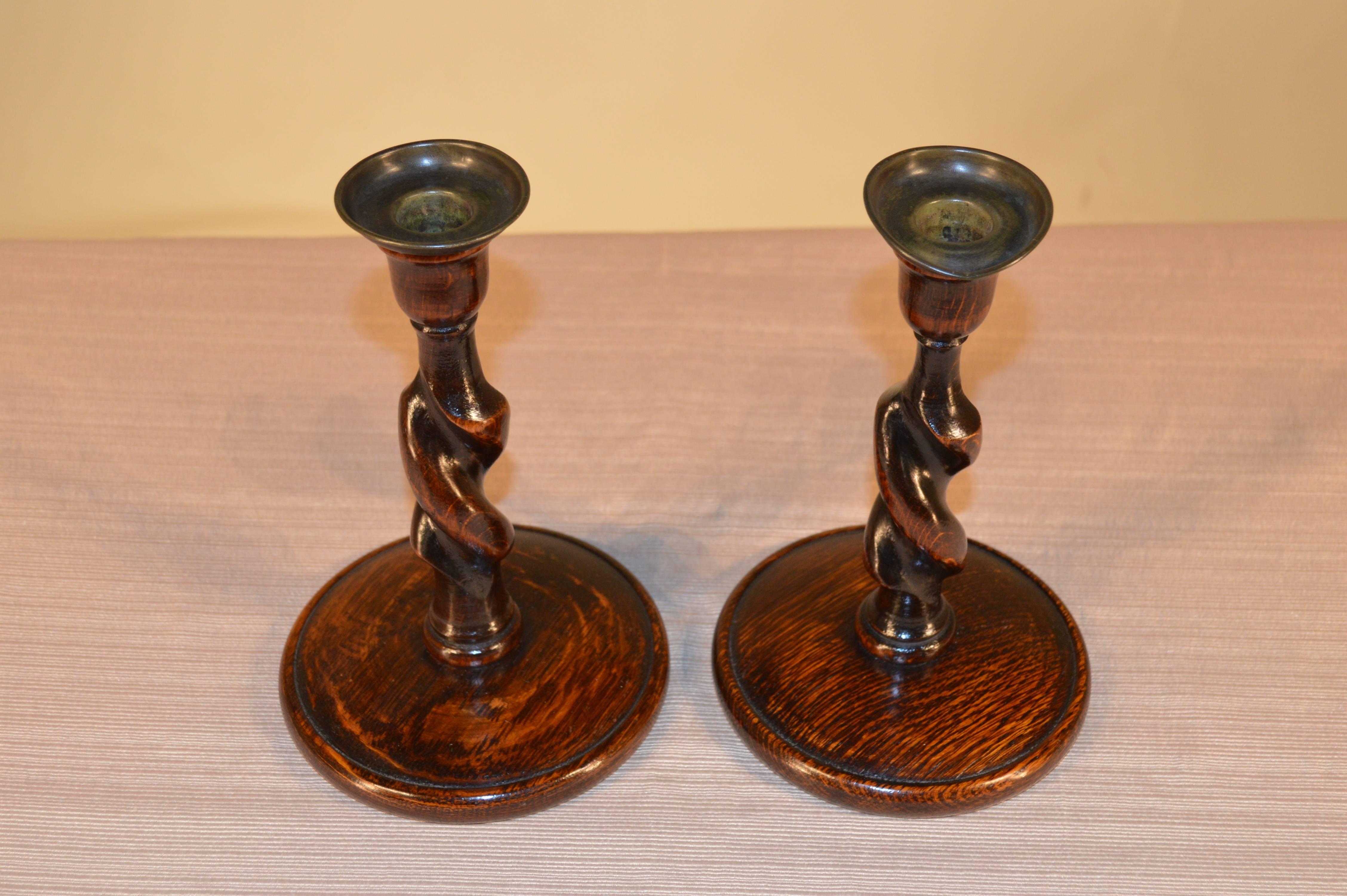 Pair of English candlesticks with large turned bases and barley twist stems, circa 1900. Age wear, bobeches bent from use.