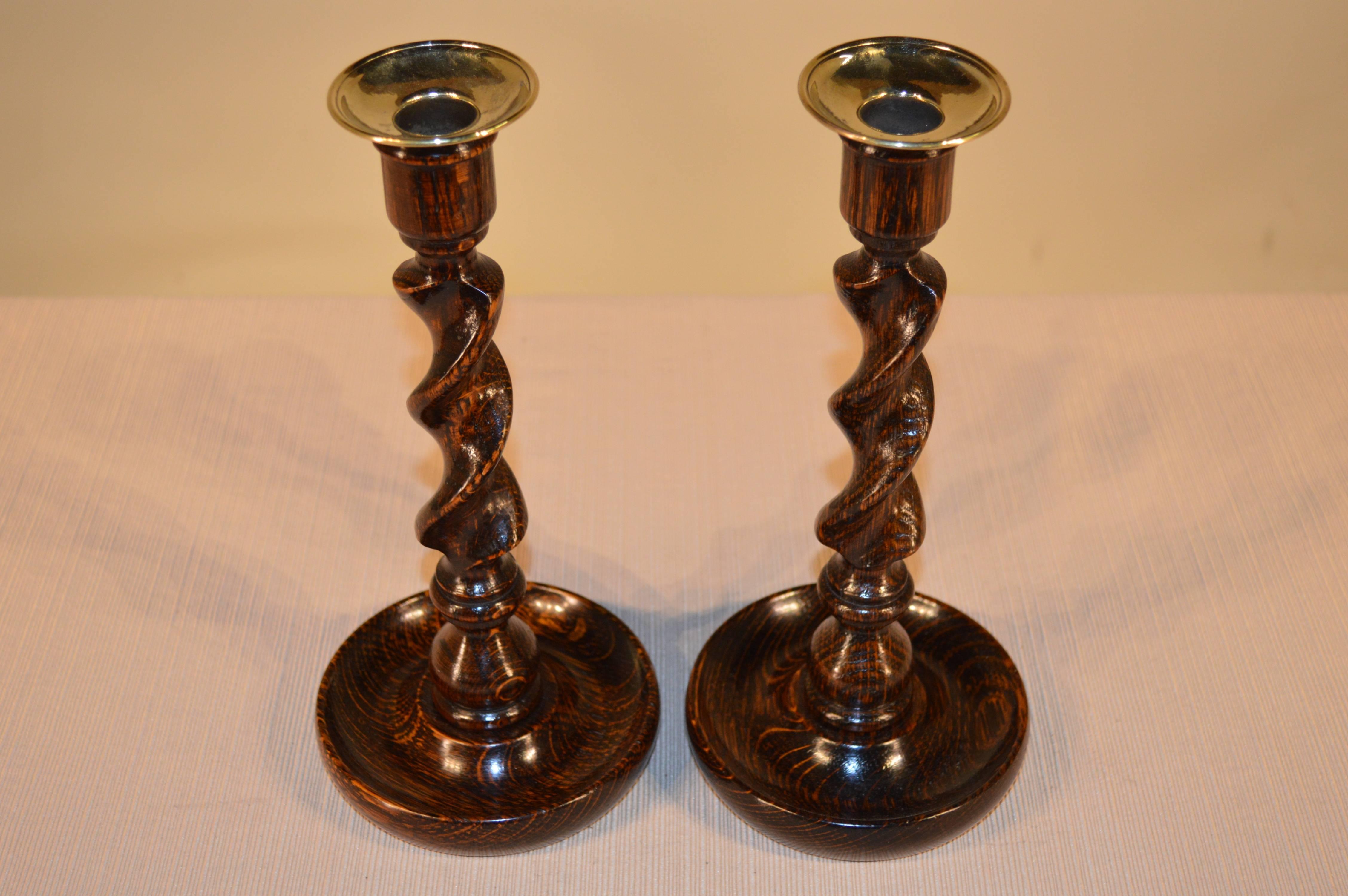 Pair of English oak candlesticks with hand-turned barley twists stems on hand-turned dish bases, circa 1900.