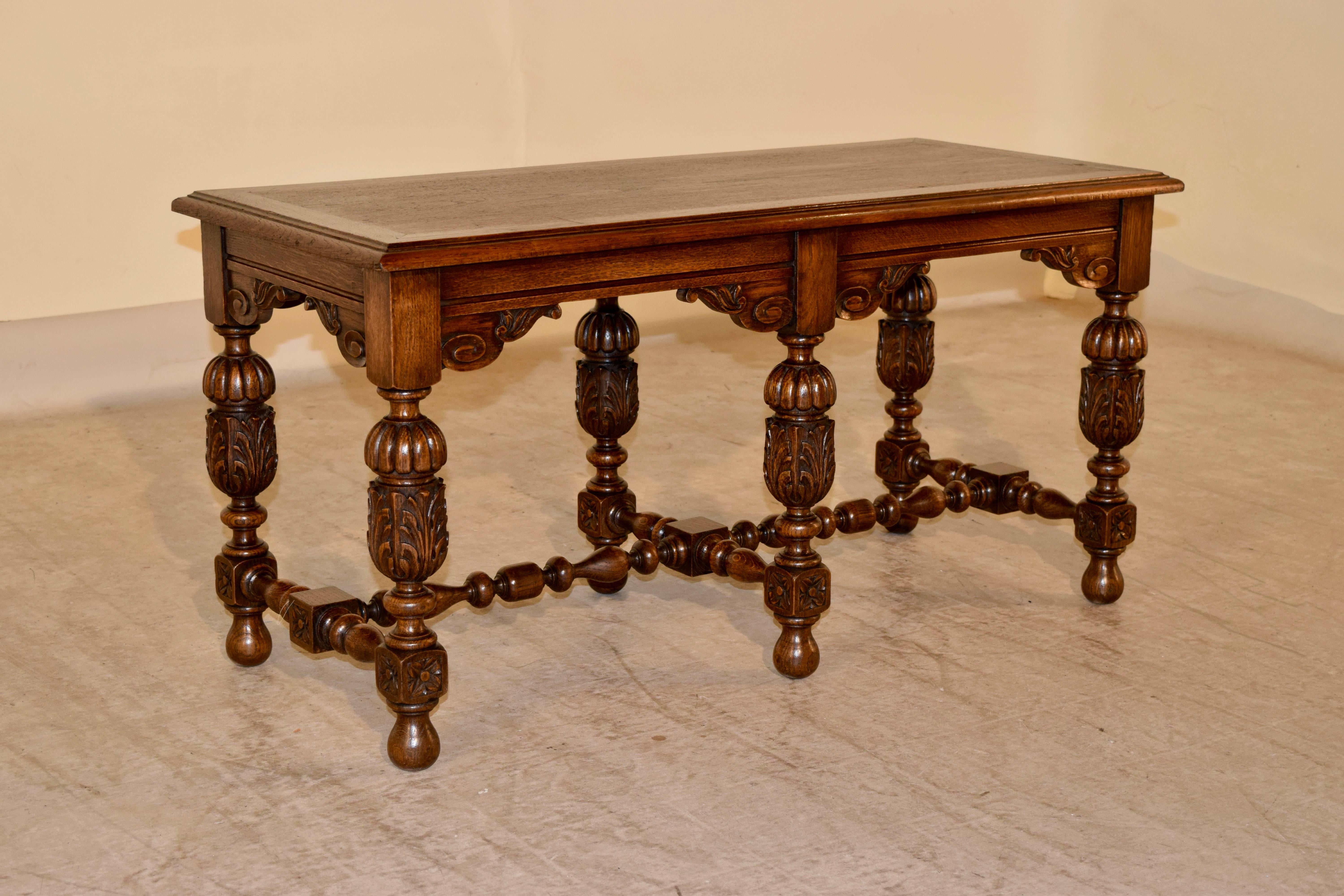 19th century English oak bench with a lovely beveled edge around the top, following down to a routed apron with hand-carved brackets. The legs are wonderfully hand-turned and carved decorated and are joined by hand-turned stretchers. Supported on