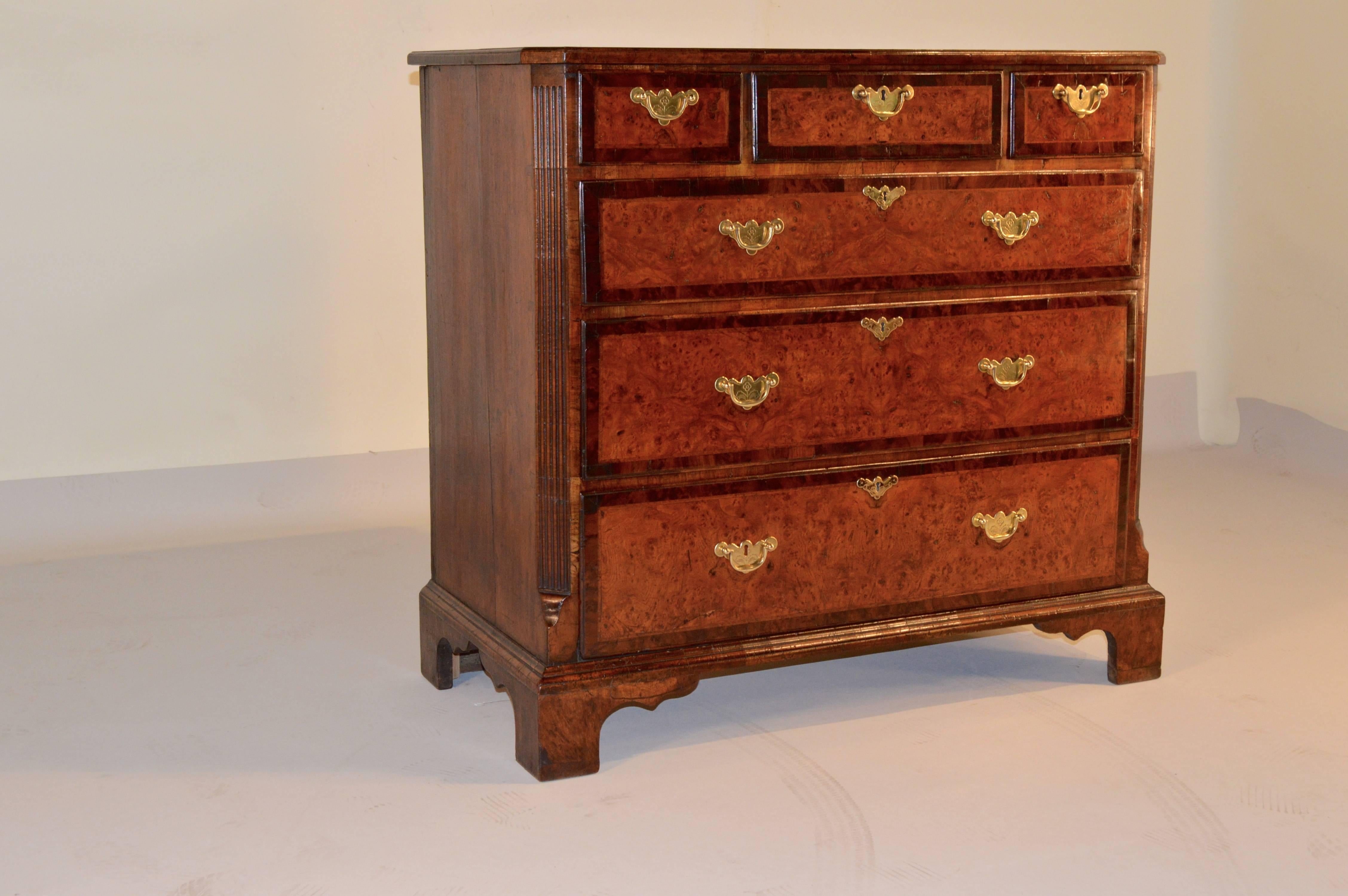 Rare 18th century English burled elm chest of drawers with mulberry banding. Three small drawers over three full-size drawers. Fluted quarter columns with lamb's tongues at top and bottom of columns. Supported on bracket feet.