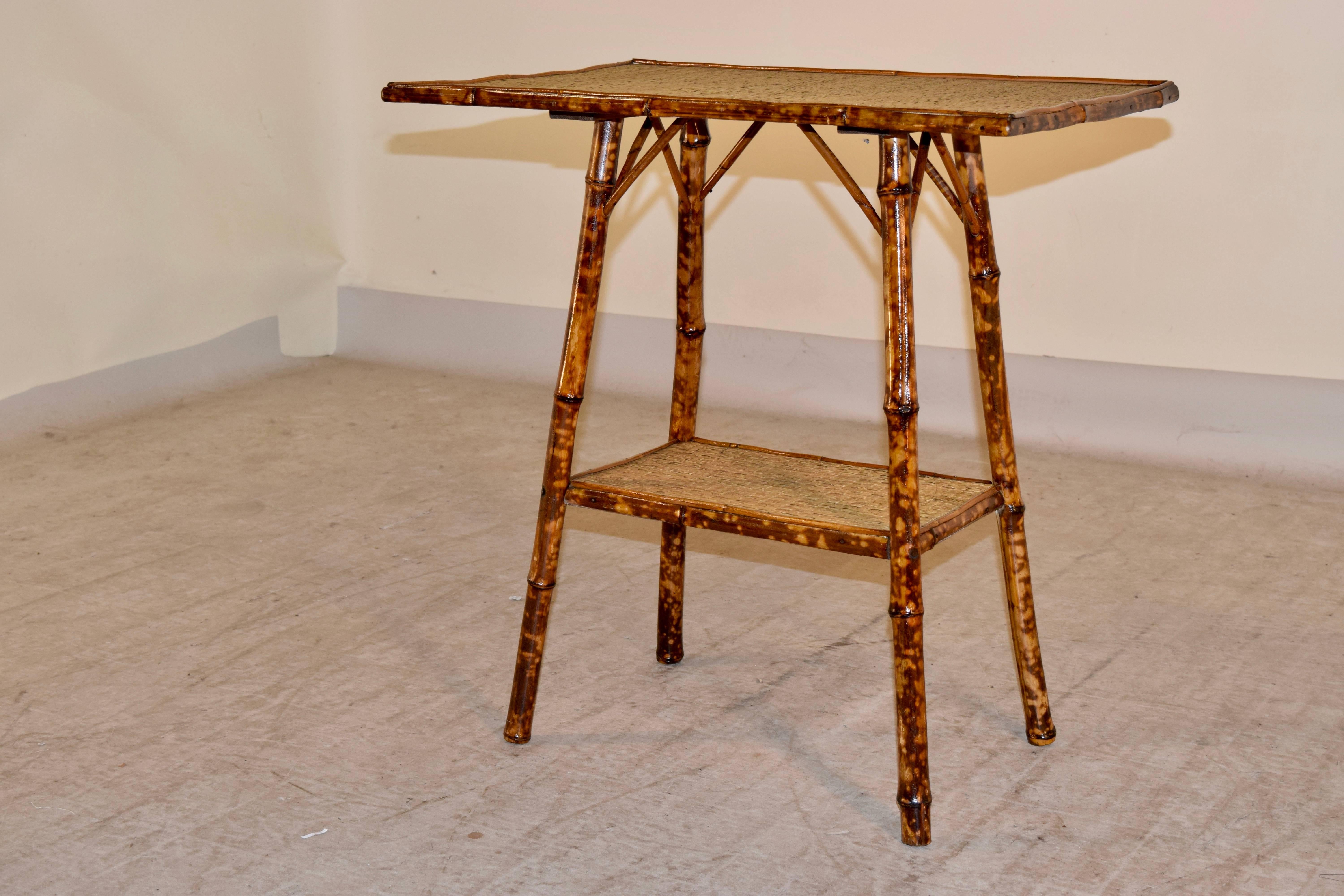 19th century tortoise bamboo side table from France. The top and lower shelf are covered in rush.