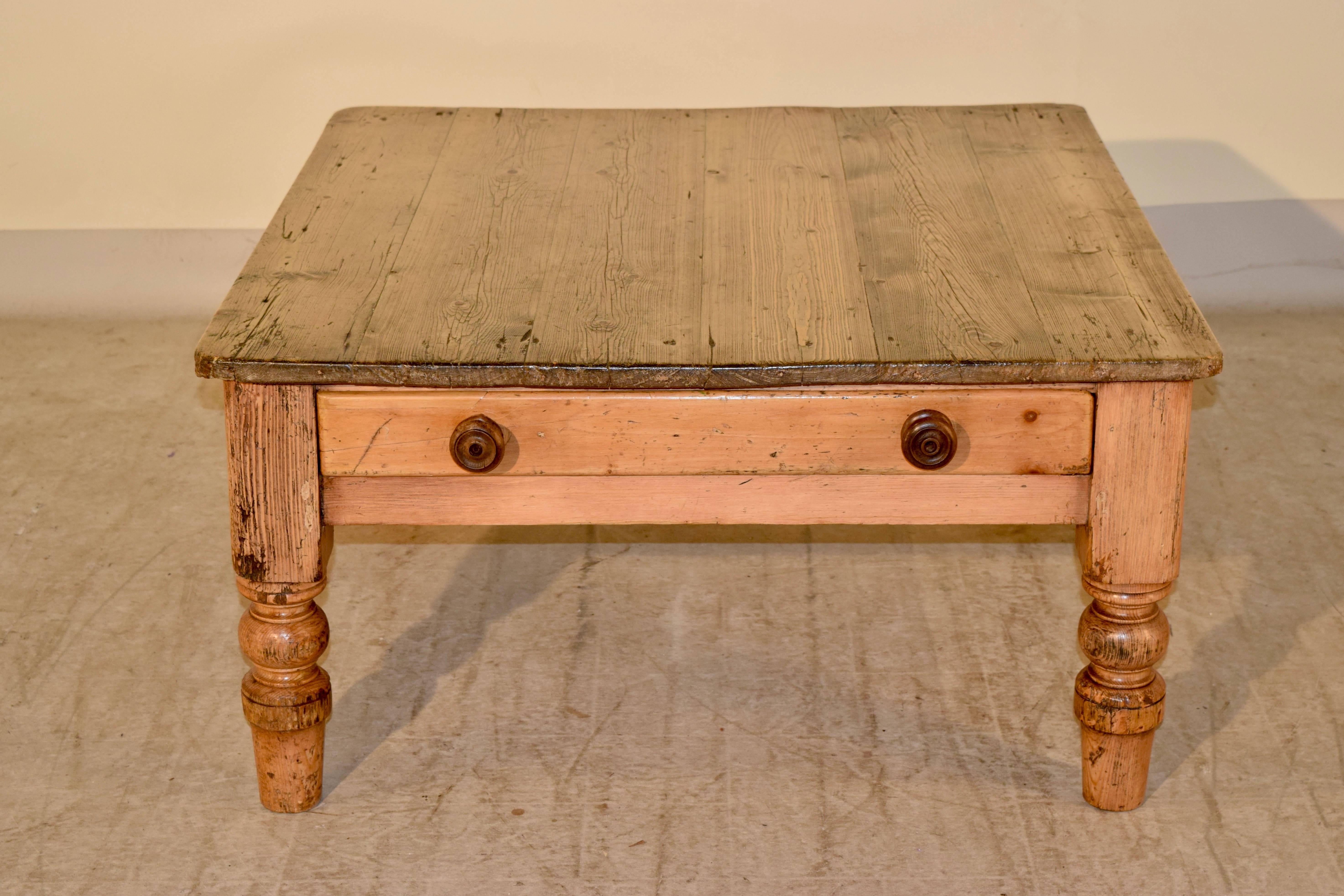 19th century English pine coffee table with a six plank top, which has rounded corners, following down to a single drawer and thickly turned legs.