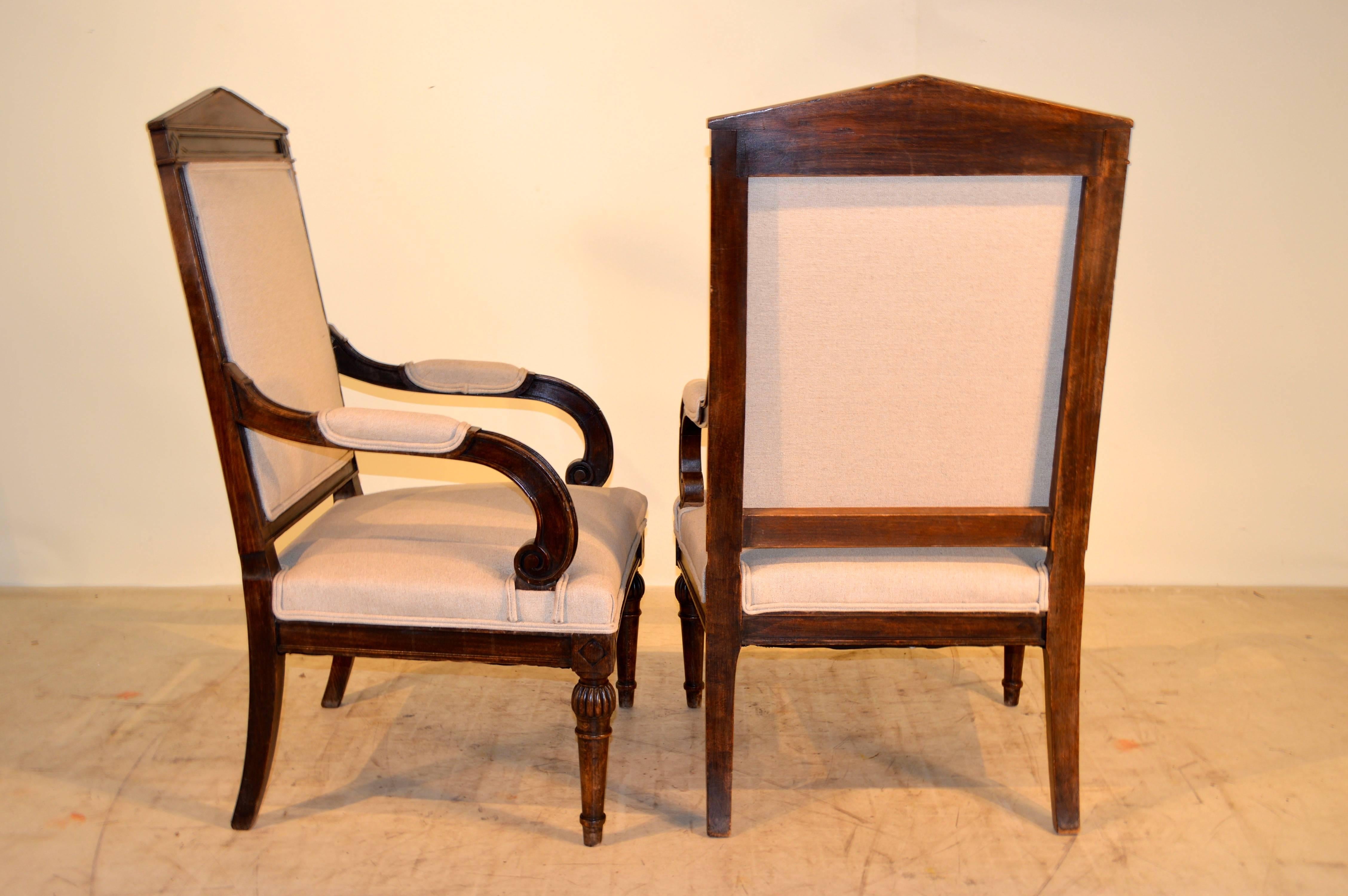 Pair of 19th century French walnut armchairs with wonderfully paneled and molded frames with beaded edge molding. Raised on carved and turned front legs and slightly splayed back legs. Newly upholstered in linen finished with double welt decoration.