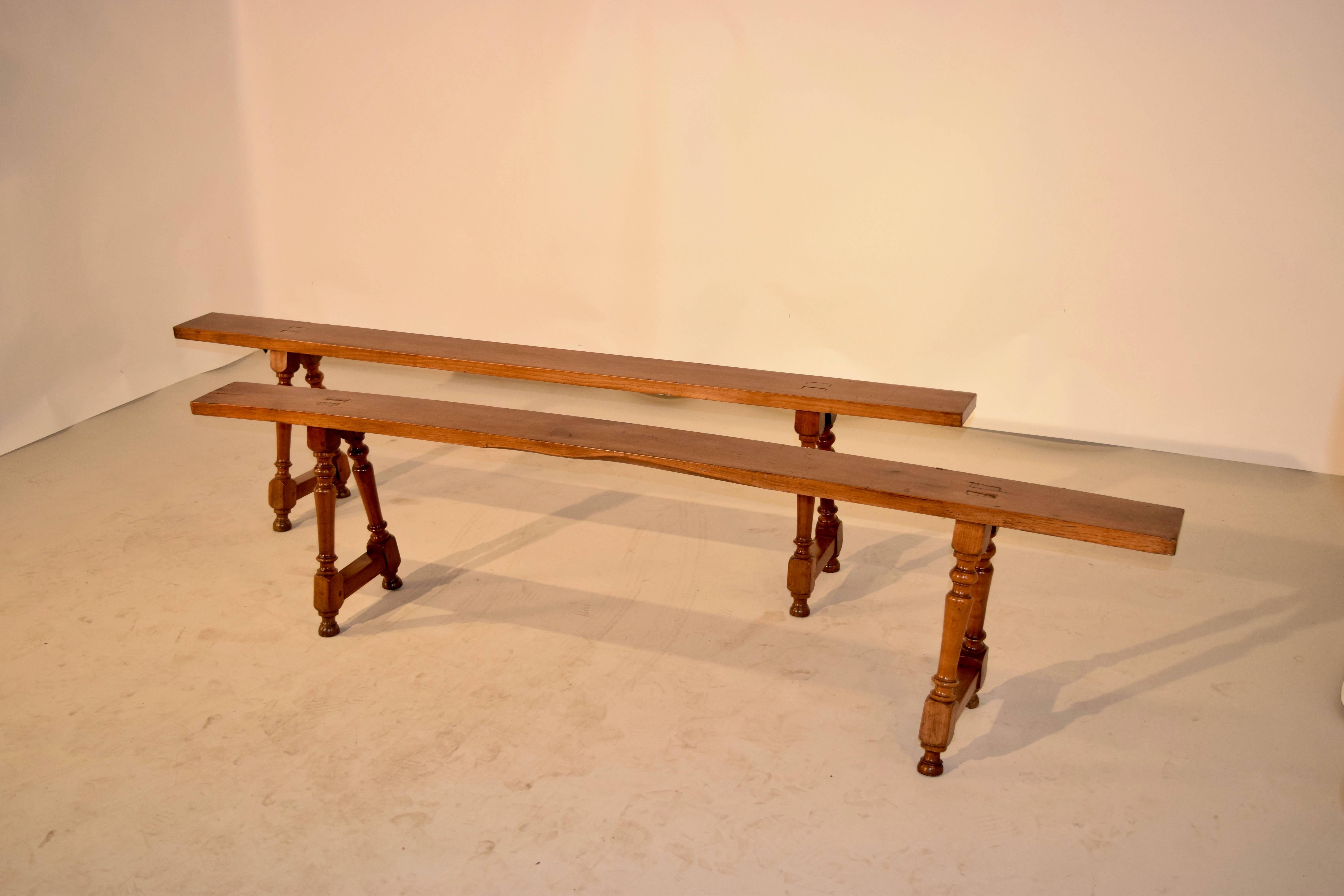 19th century pair of cherry benches from France. They are simply constructed with exposed mortises, and have wonderfully turned bases. One seat has a slight bow from age. The seat depth is 5.88.