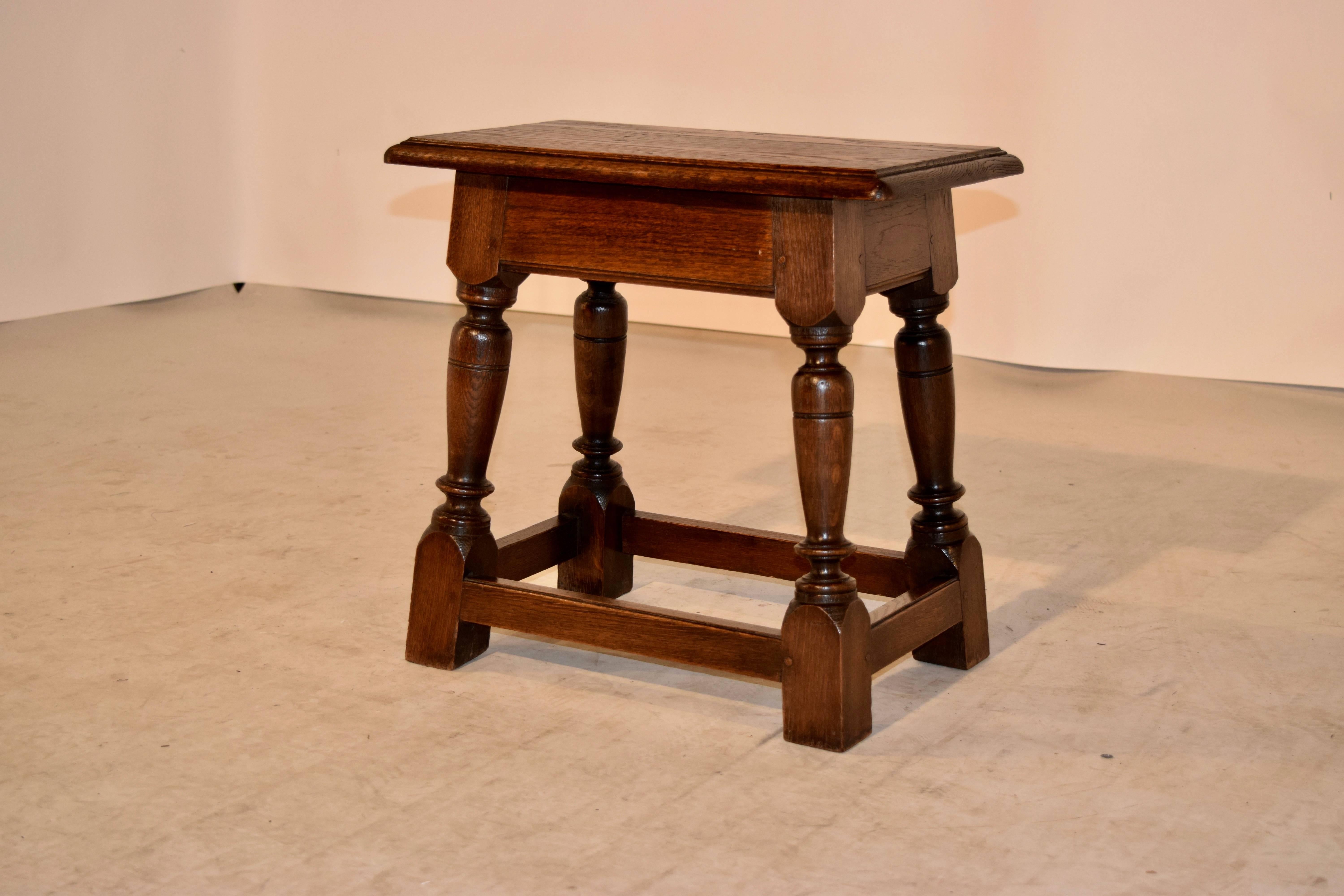 19th Century English joynt stool made from oak. The top has a molded and beveled edge around the top following down to a simple apron and simple hand-turned legs, joined by stretchers. Wonderful pegged construction.
 