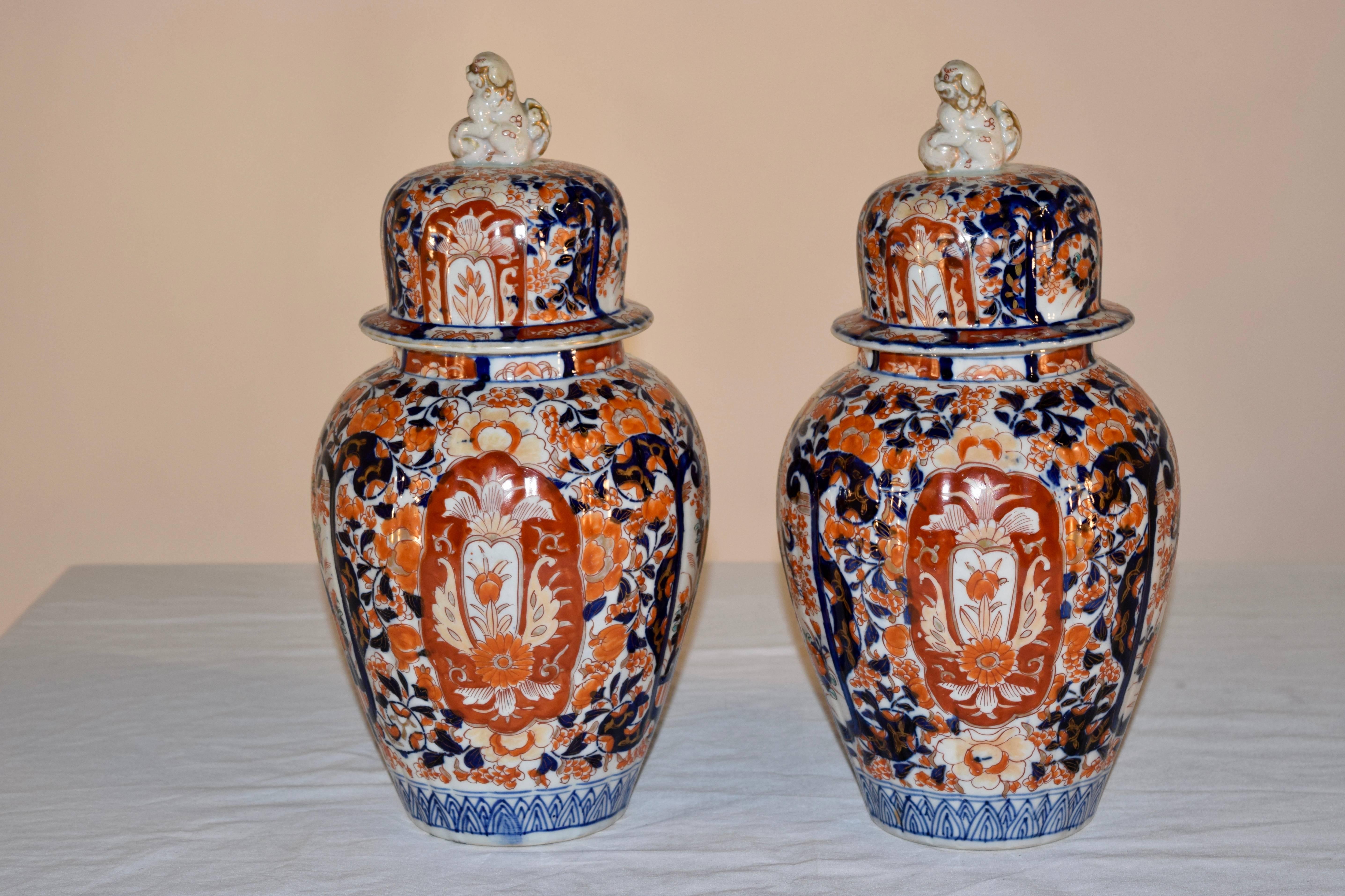 19th century pair of lidded Imari jars in gorgeous colors of cobalt, orange and gold. The hand-painted designs are of mostly florals and trees. They are in beautiful condition.