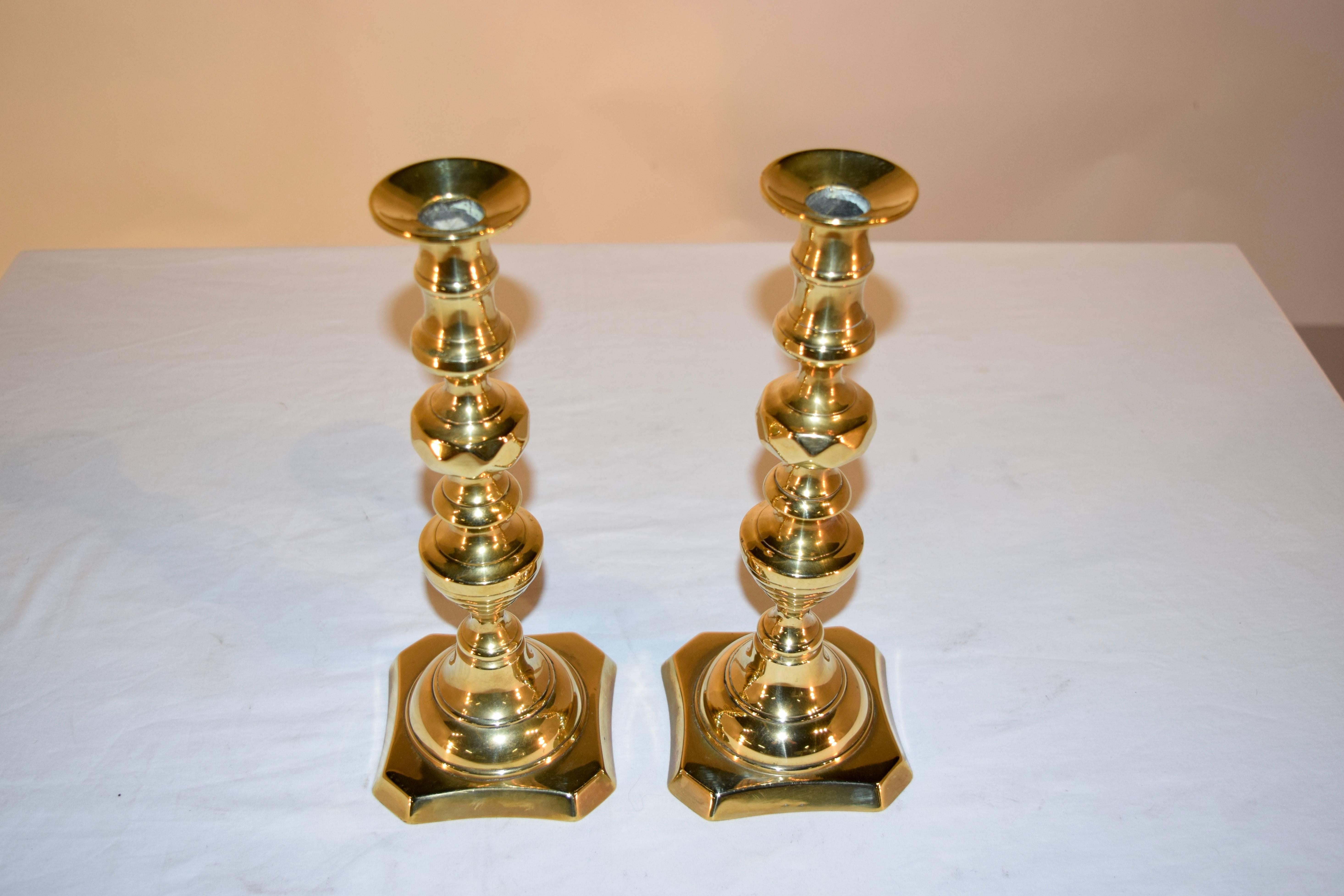 Pair of 19th century English brass candlesticks in a beehive and diamond pattern.