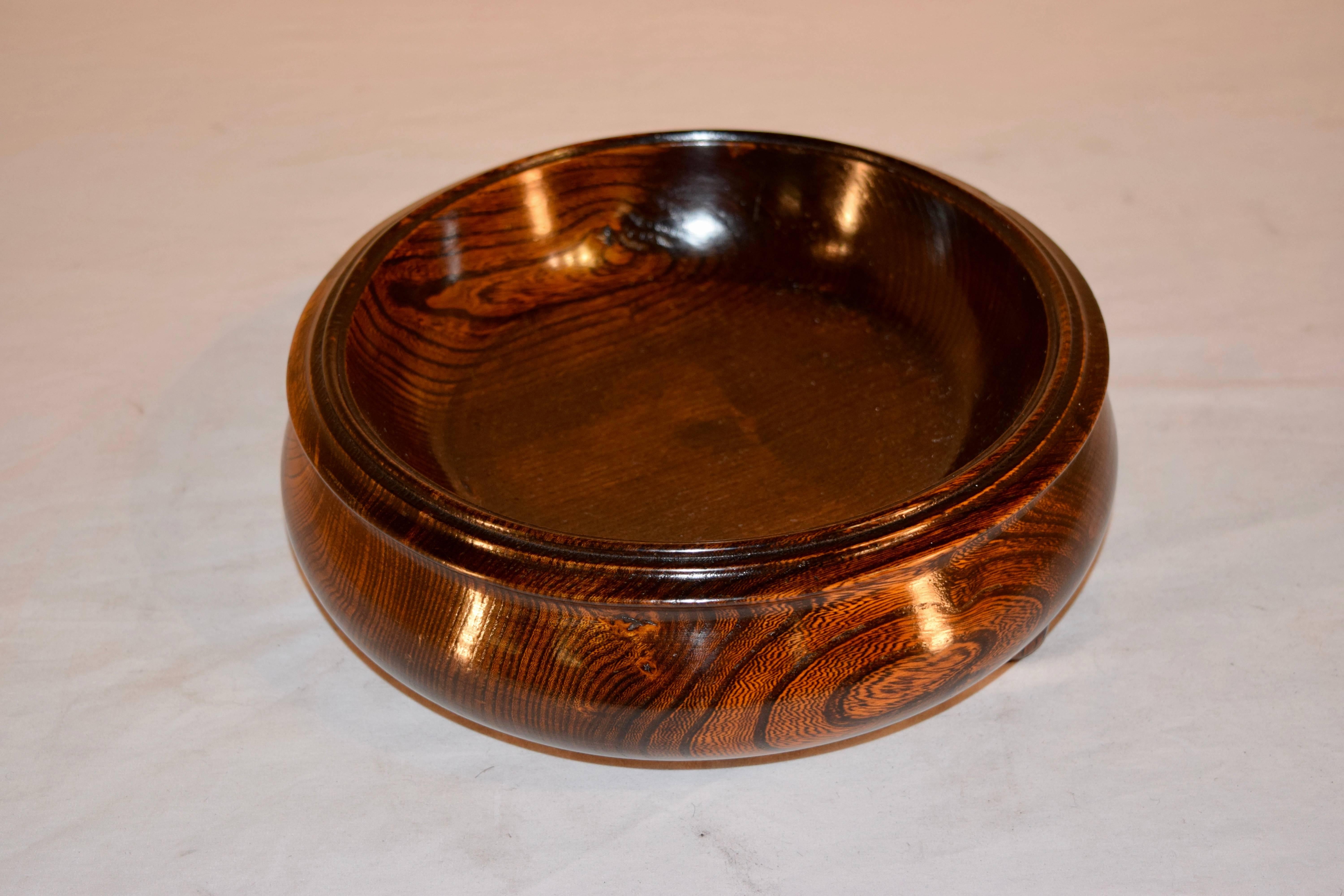 19th century hand-turned bowl from England. Made from oak with turned feet.