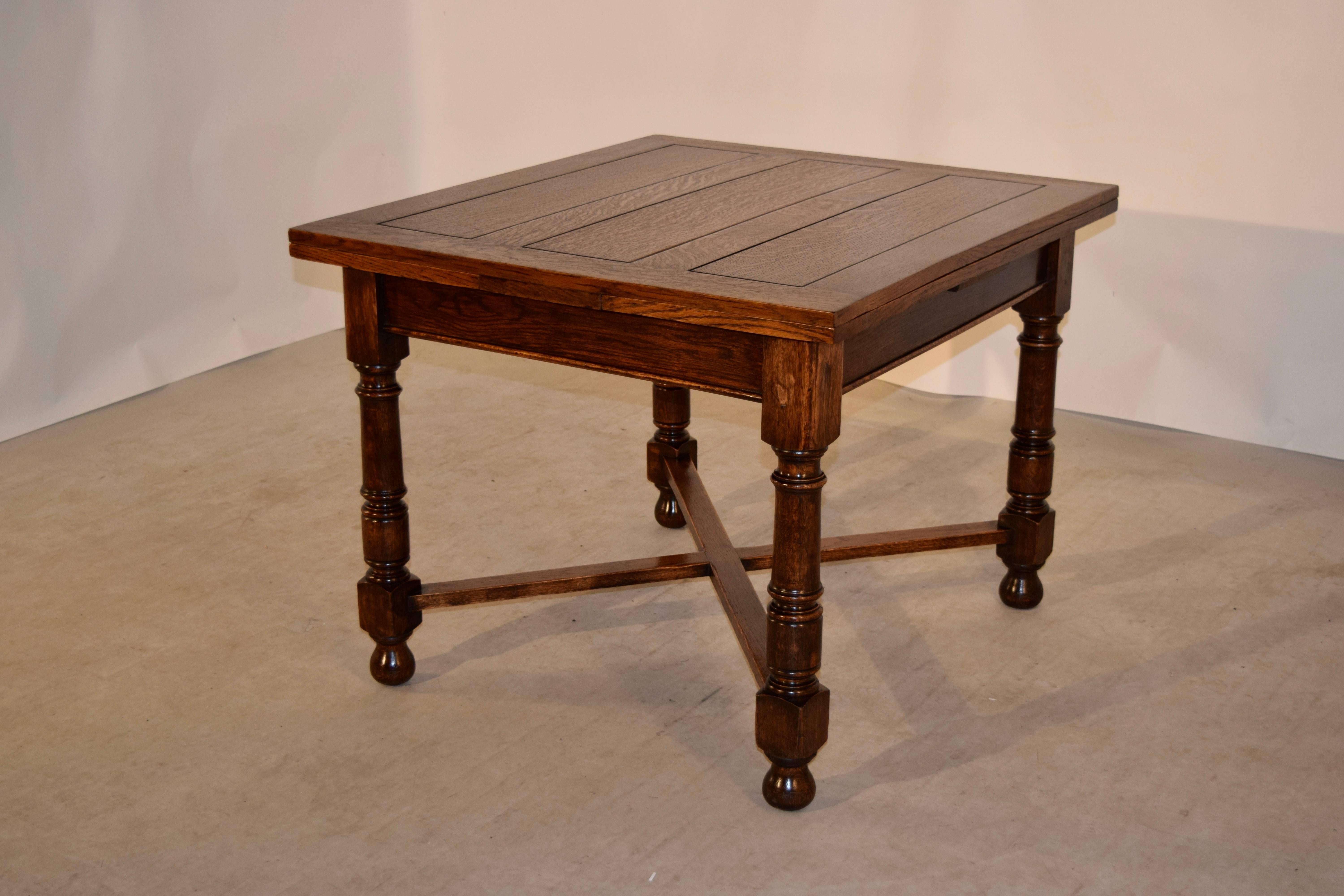 English oak draw leaf table, circa 1900 with a panelled top and leaves, following down to a simple apron and gun barrel hand turned legs, joined by cross stretchers and ending in hand turned feet. The top open measures 63.75 x 38.63.