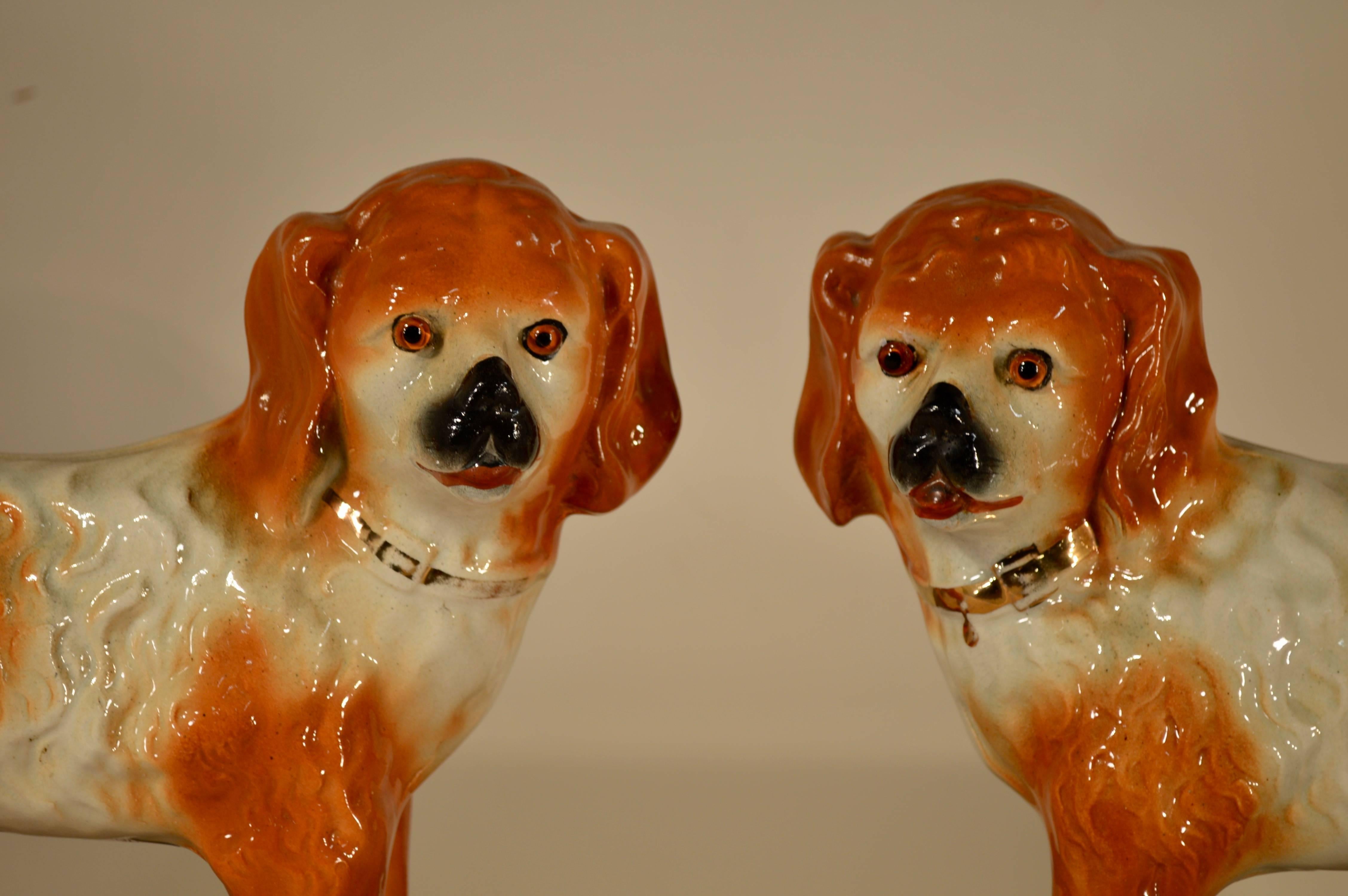 Late 19th century pair of English Staffordshire standing dogs. Each measures 14 L x 6 W x11 H.
   