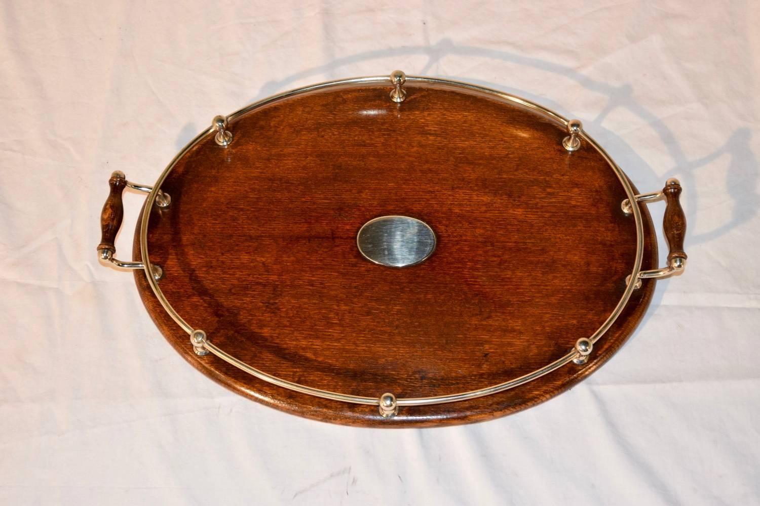 English oak tray with silver-plated gallery and central plaque, circa 1900.