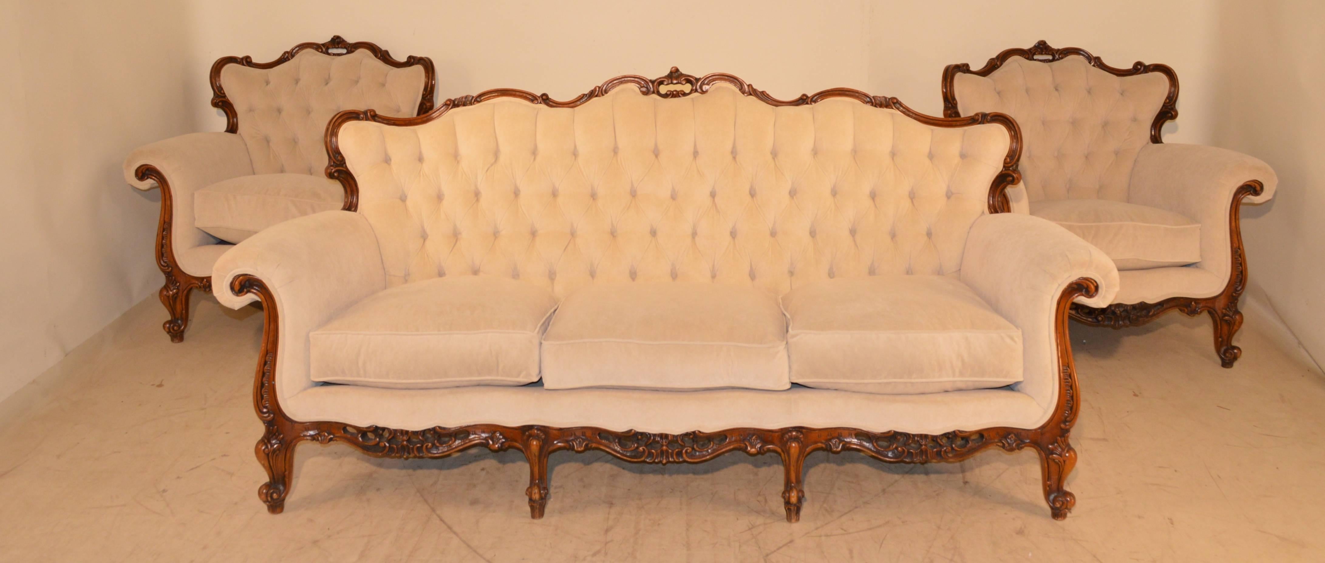 This is the most wonderful and comfortable parlor set we've ever had! The frames are solid walnut with hand-carved decoration and we had them re-upholstered in the same pattern in which they were originally. The three pieces are covered all the way
