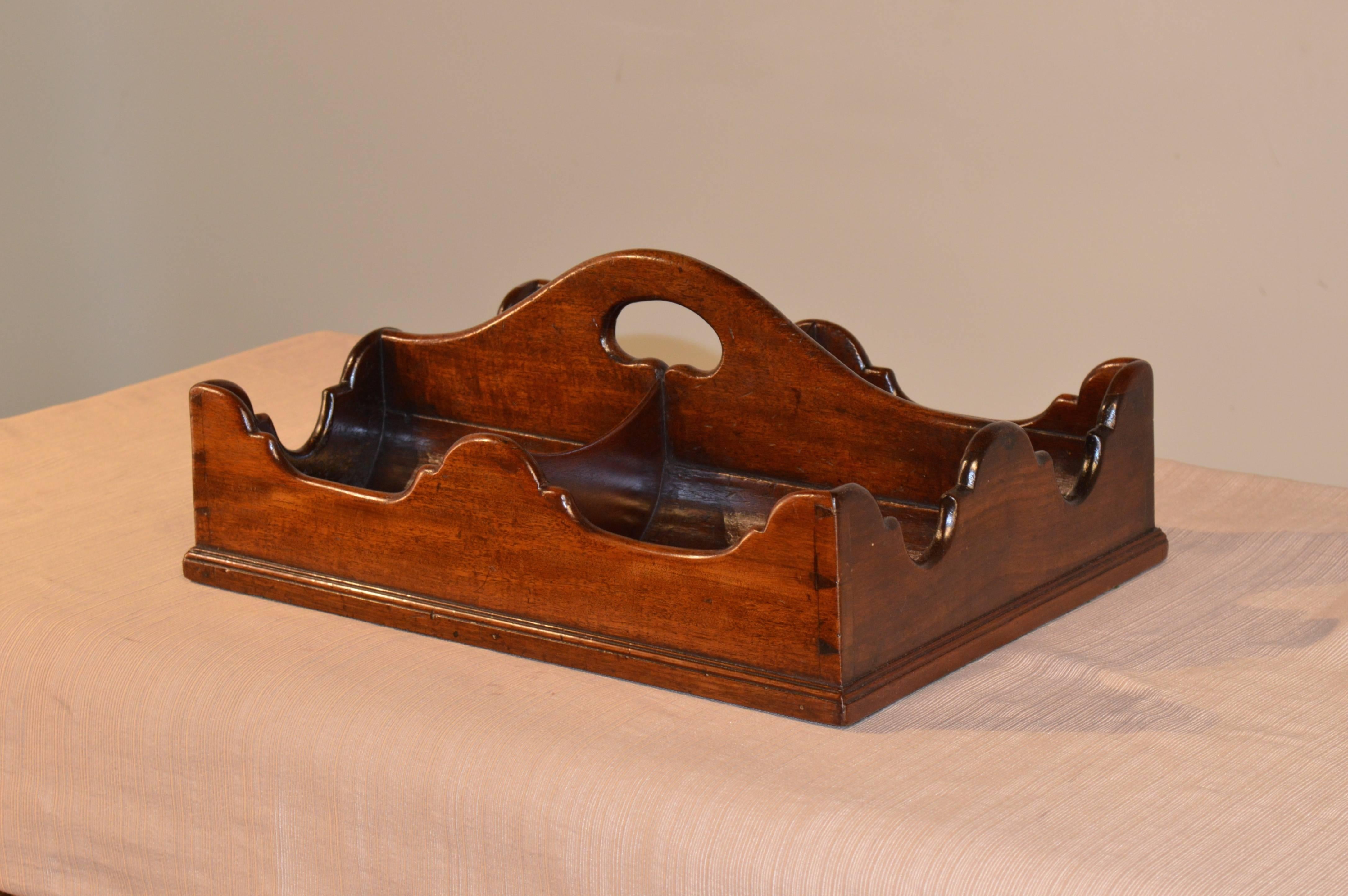 Period George III mahogany wine caddy with four bottle sections. The sides are beautifully scalloped and constructed with dovetails. The bottom is beautifully molded. A rare Georgian treasure.